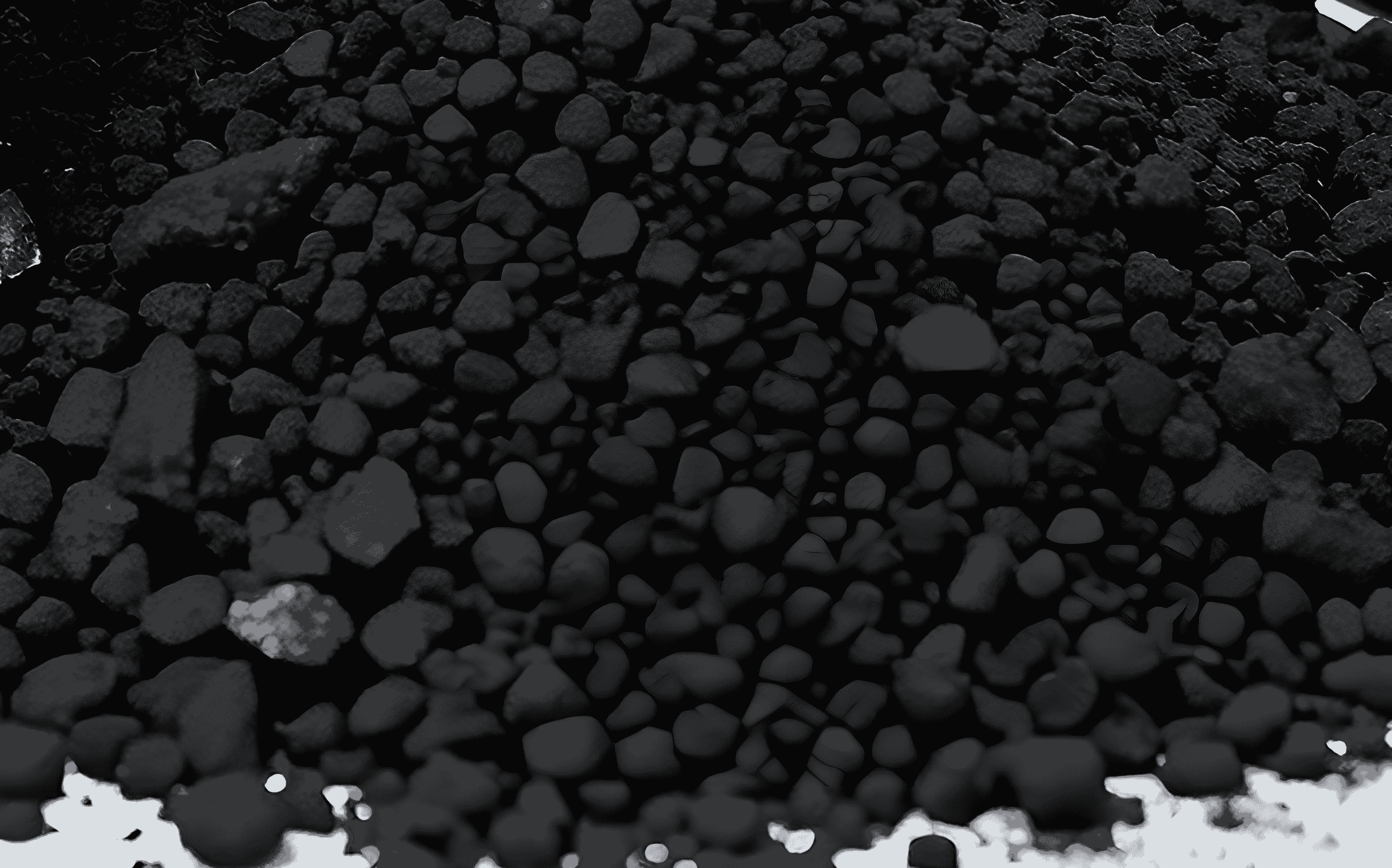 Close-up of black granules or gravel with a rough texture.