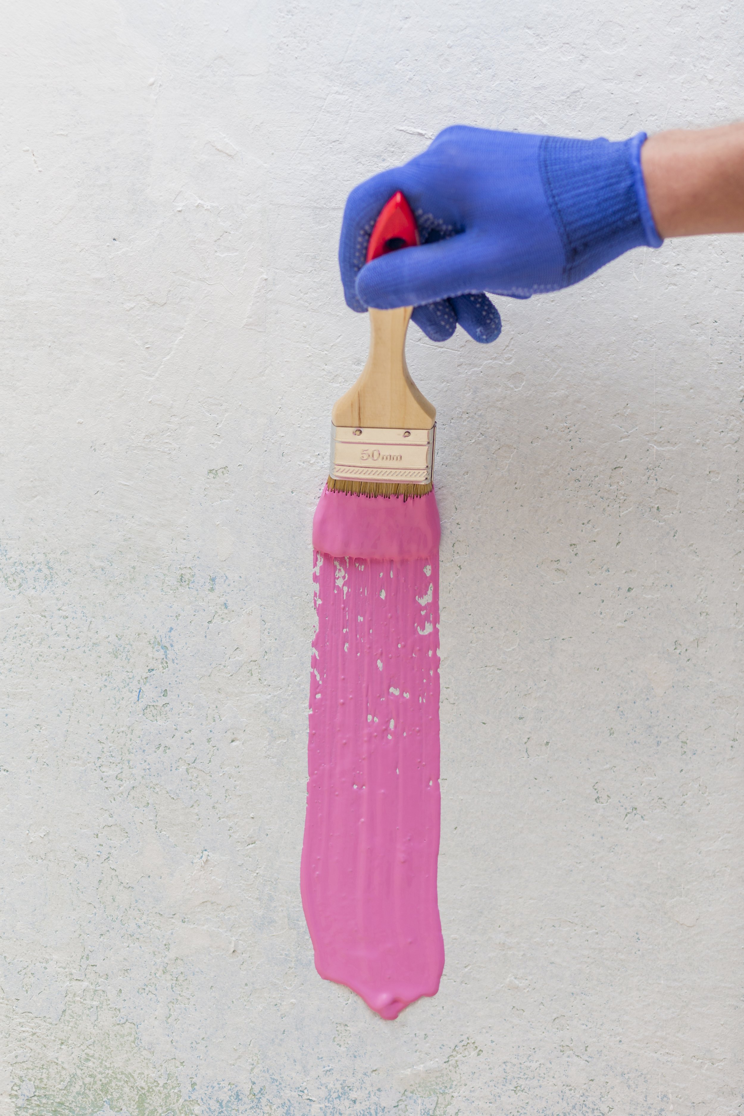 top-view-hand-holding-brush-with-pink-paint.jpg