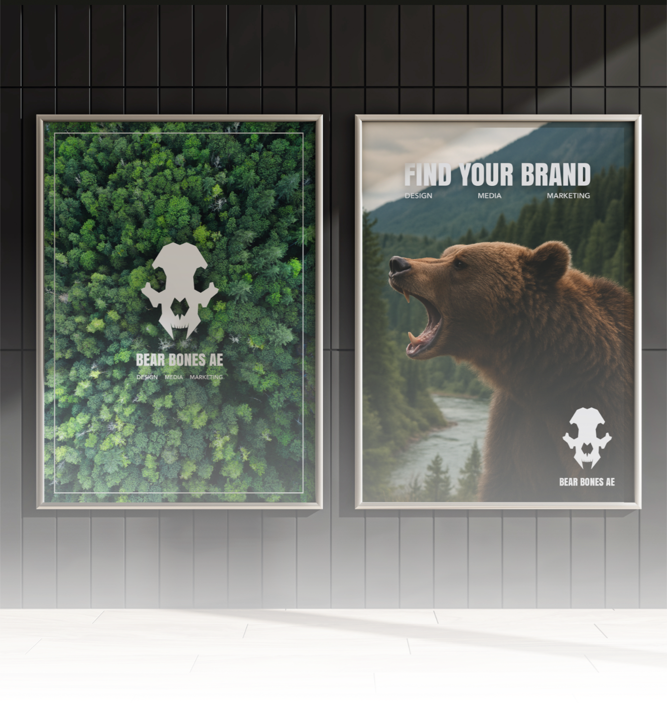 Two framed posters on a black wall. The left poster features a dense green forest with a skull logo in the center and the text "BEAR BONES AE" and "DESIGN MEDIA MARKETING." The right poster shows a roaring bear with mountains and trees in the background and the text "FIND YOUR BRAND" with additional smaller text "DESIGN MEDIA MARKETING." Both posters have the Bear Bones AE logo in the lower corner.