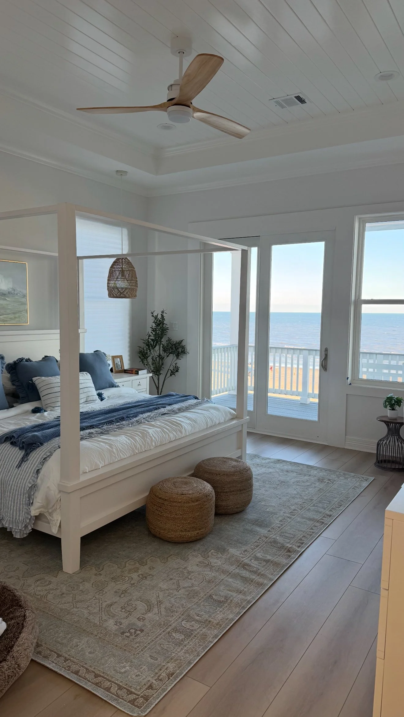 Canopy Bed with beach background woven poufs with blue bedding- Virtual Interior Design Services used from Etsy Design Services 