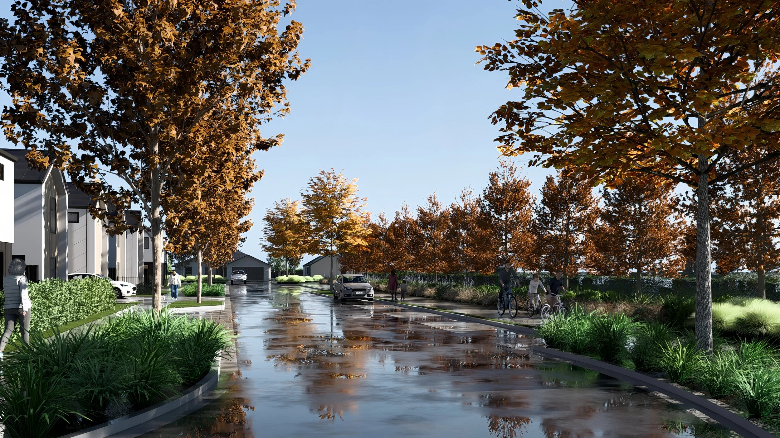 A residential street scene with autumn trees lining the sidewalk, wet pavement reflecting the sky, and people walking or biking.