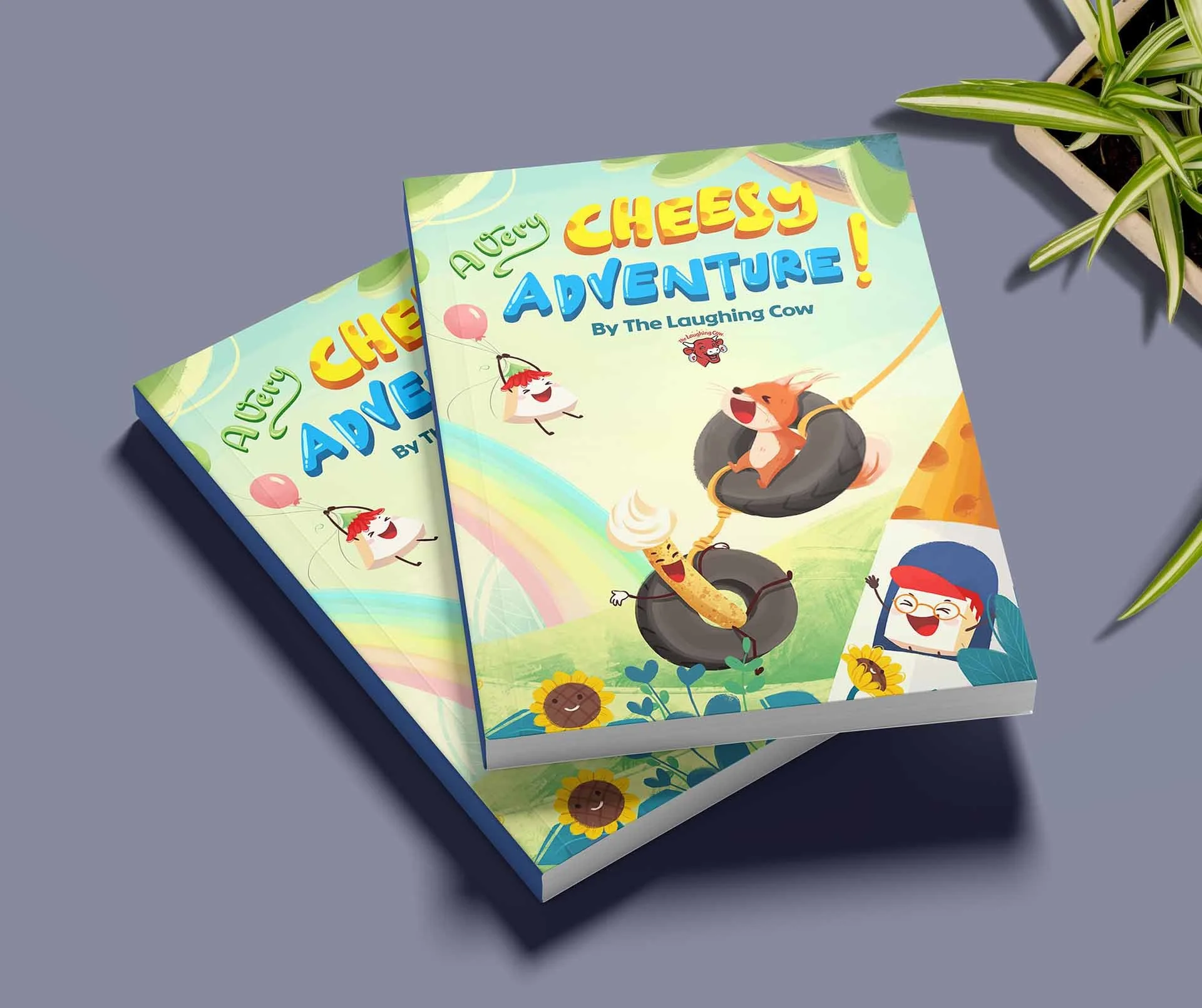 Colorful children's book titled 'A Very Cheesy Adventure' featuring cartoon cheese, rats, and a happy kid with glasses, set on a gray surface with a potted plant nearby.