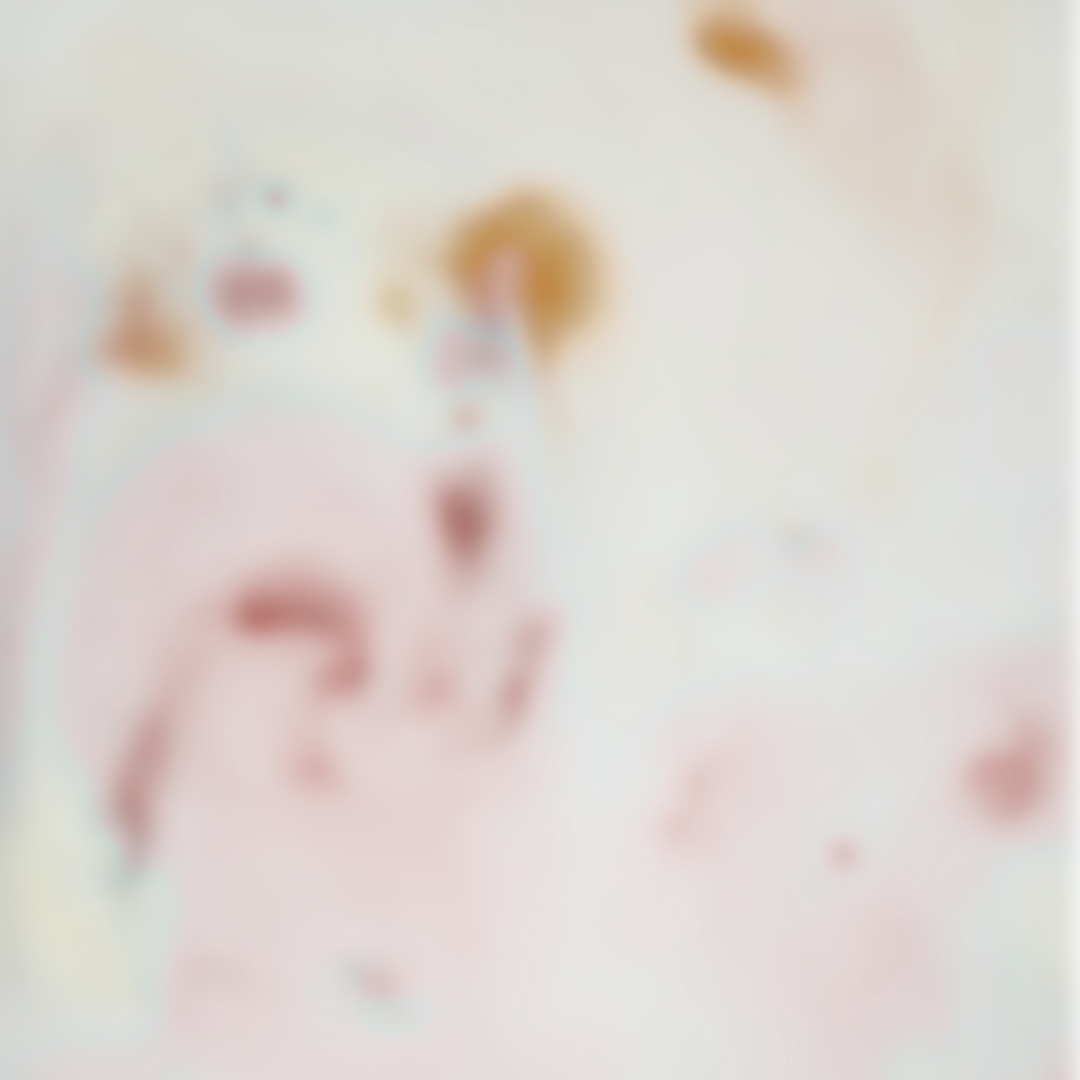 Abstract, blurred image with soft pastel colors, including pink, white, and touches of orange and blue.