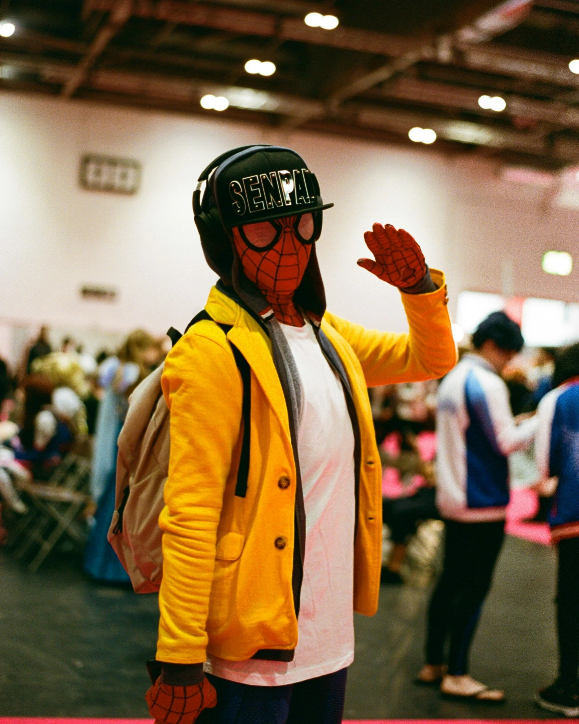 a young person in a spider man suit with a white tshirt and yellow jacket