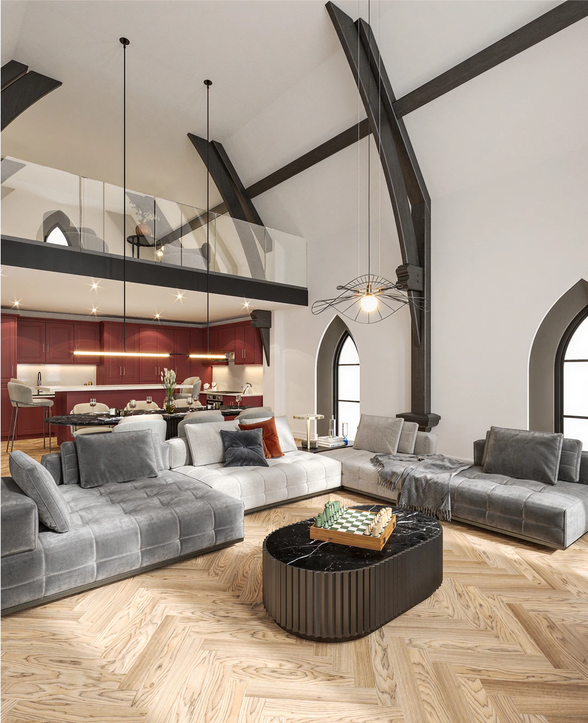 Modern living room with gray velvet sectional, black marble coffee table with chess set, and red kitchen in the background.