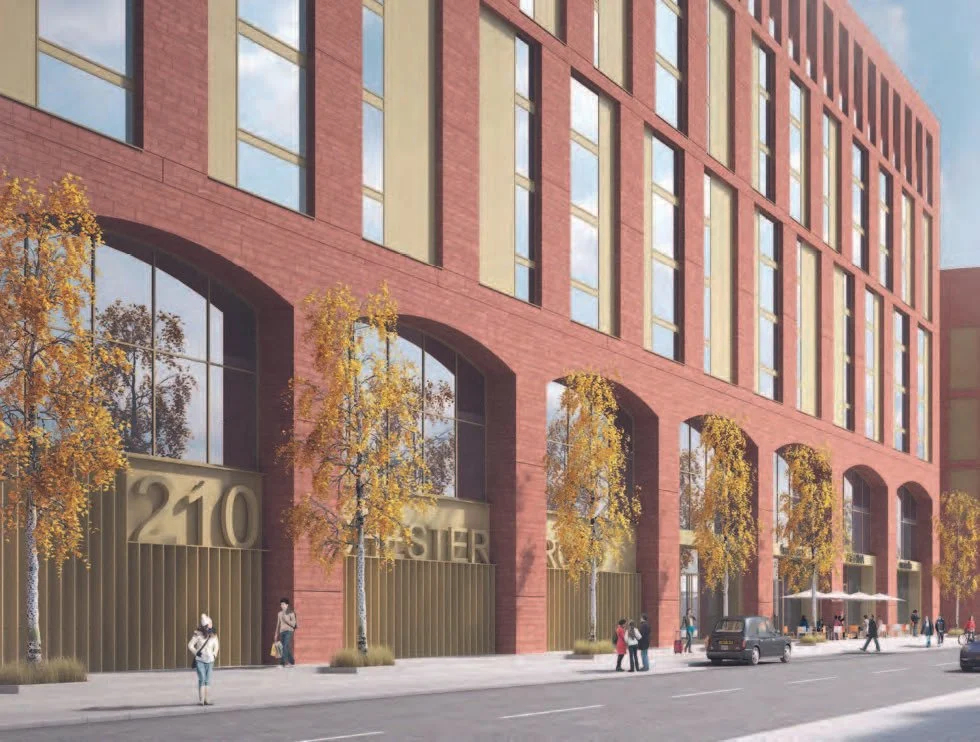 Rendering of a modern multi-story brick building with large windows and gold-colored accents at street level. Trees with autumn leaves line the sidewalk, and people are walking or standing around, with a few cars on the street.