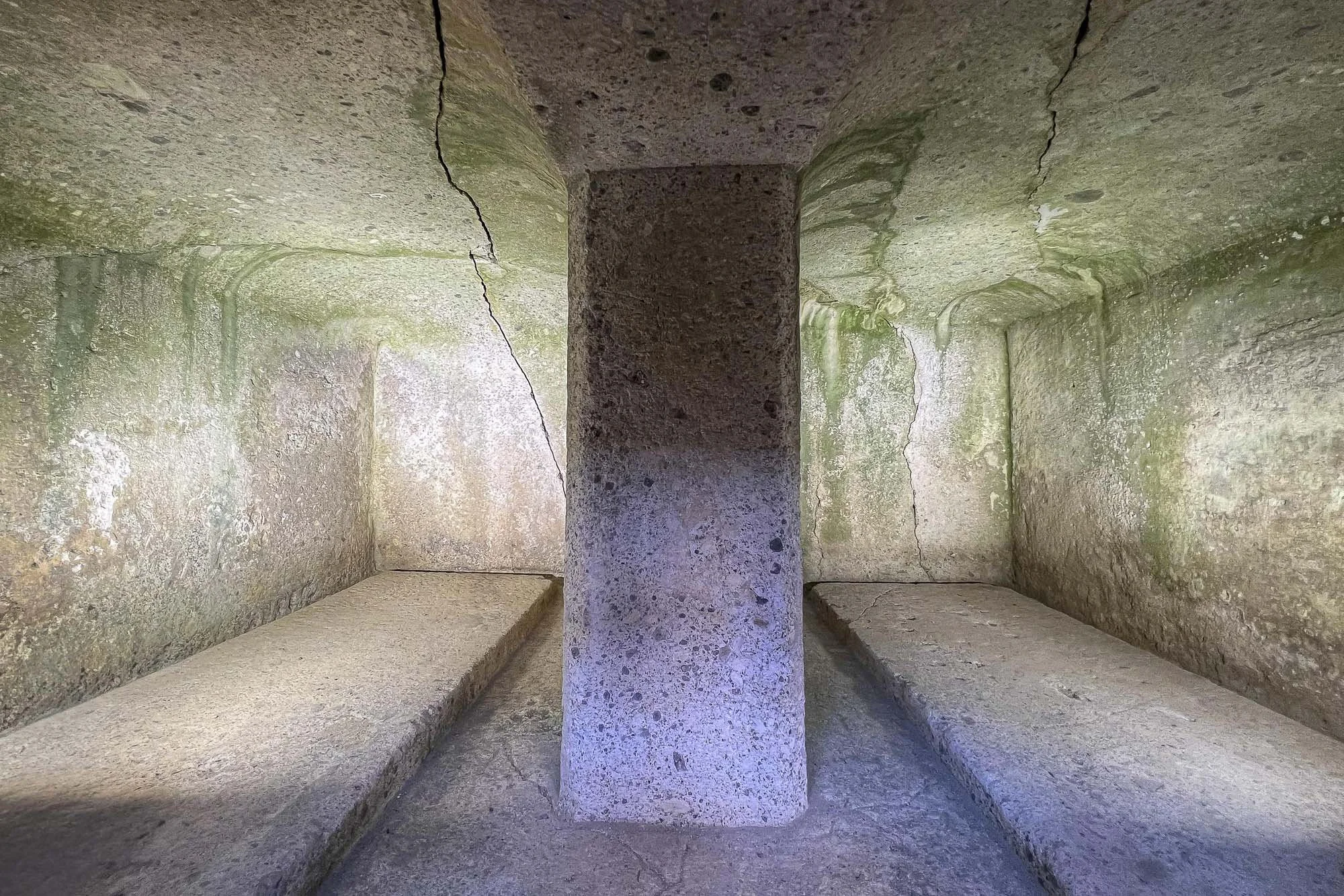 Interior of Kengoshizuka Kofun's stone burial facility, showing two chambers divided by a central stone partition.