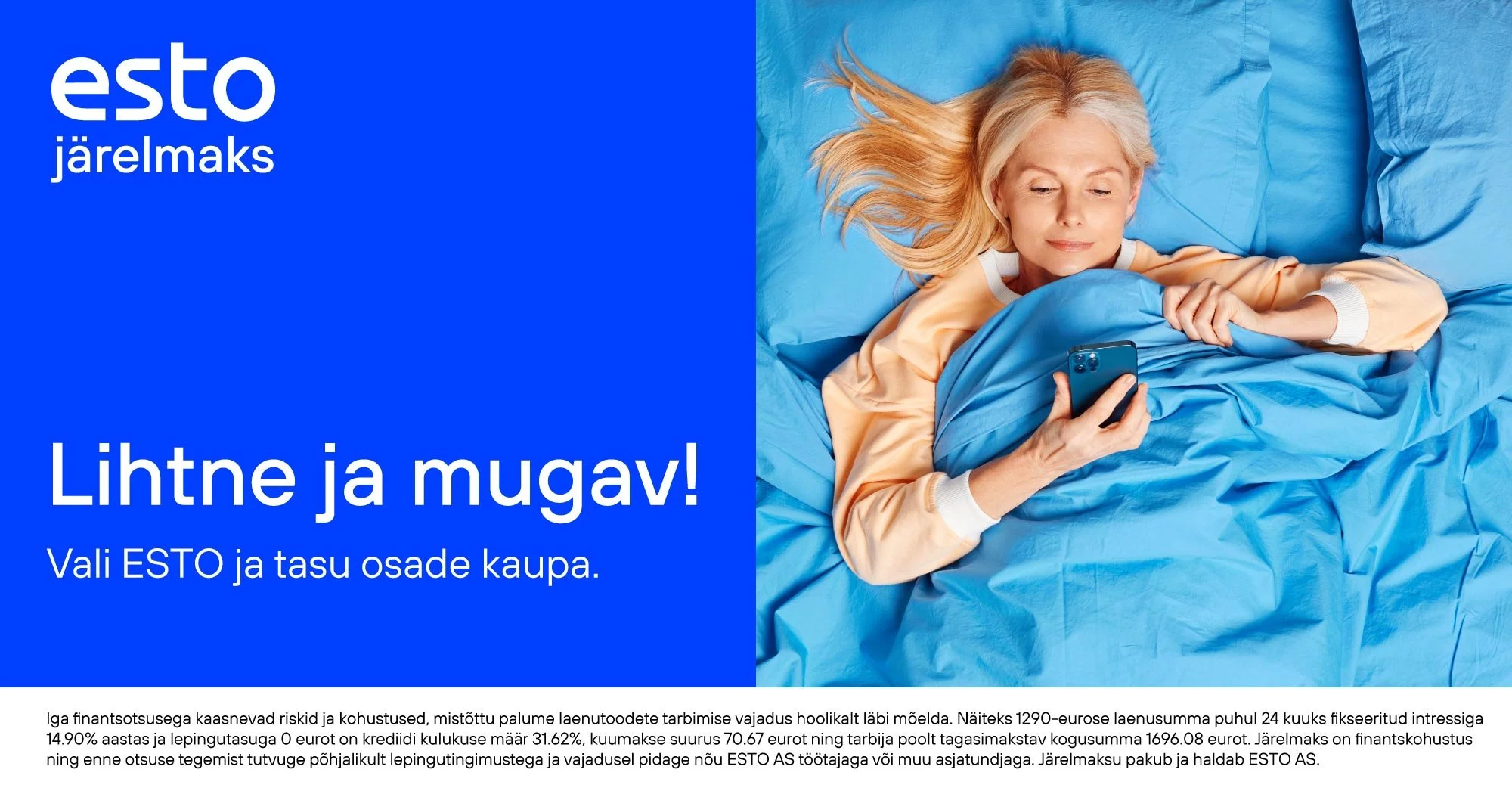 A woman lying in bed, looking at her smartphone, with blue sheets and a blue pillow, smiling with her blonde hair spread out.