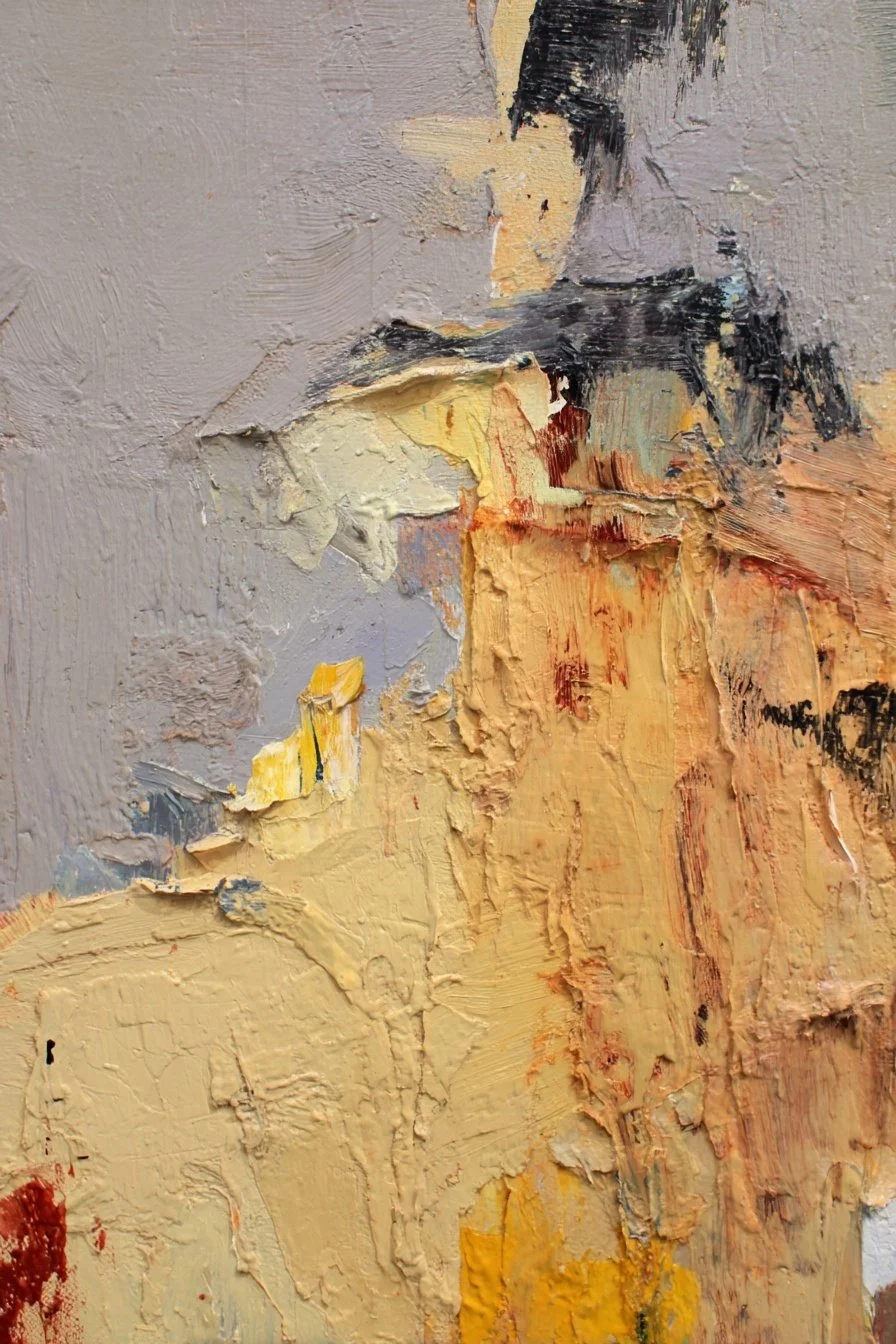 Close-up view of an abstract oil painting with thick textured brushstrokes in shades of cream, beige, black, yellow, and hints of orange and red.