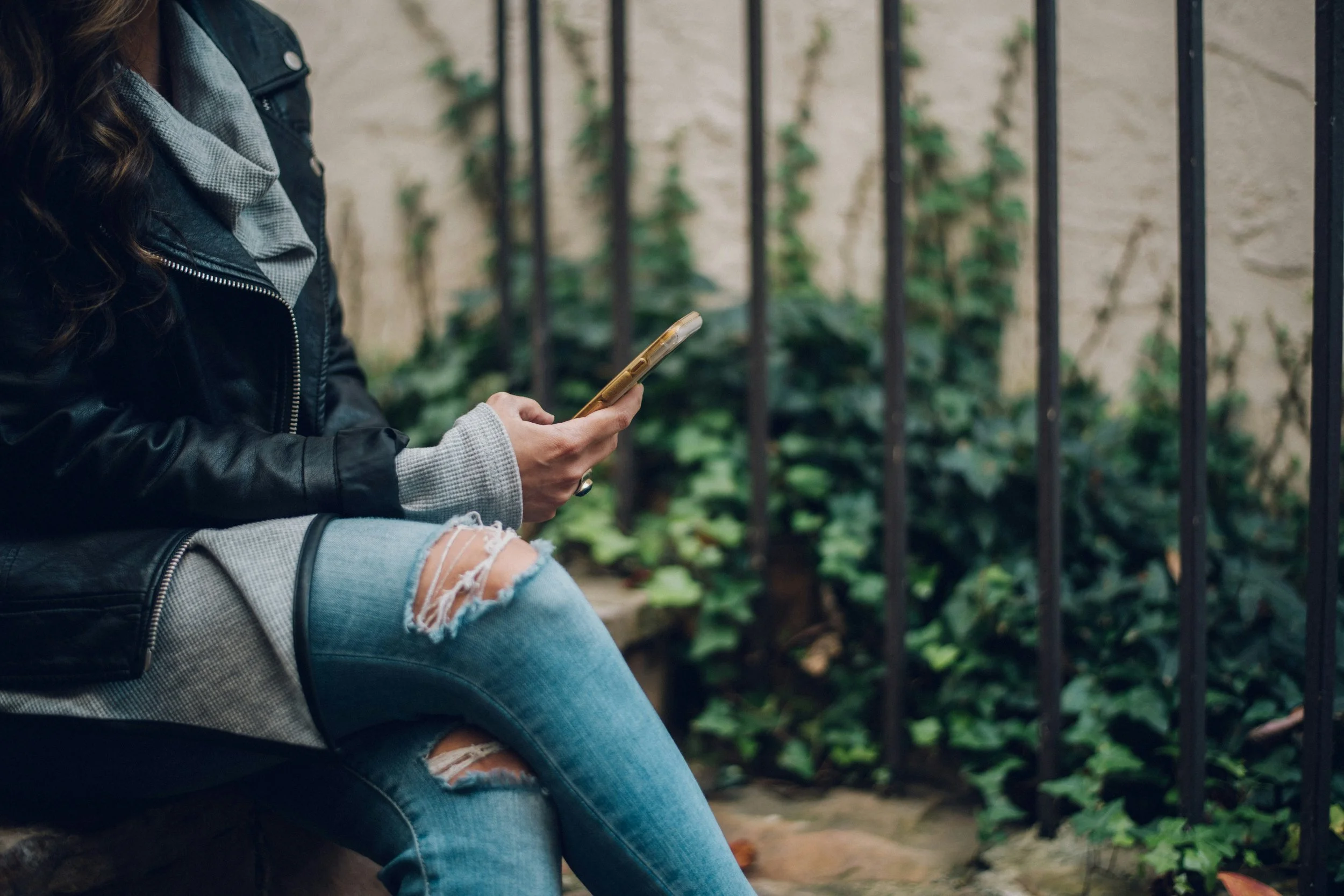 Woman using her phone, representing decisions around ignoring a ghoster explained by ghosting psychology.