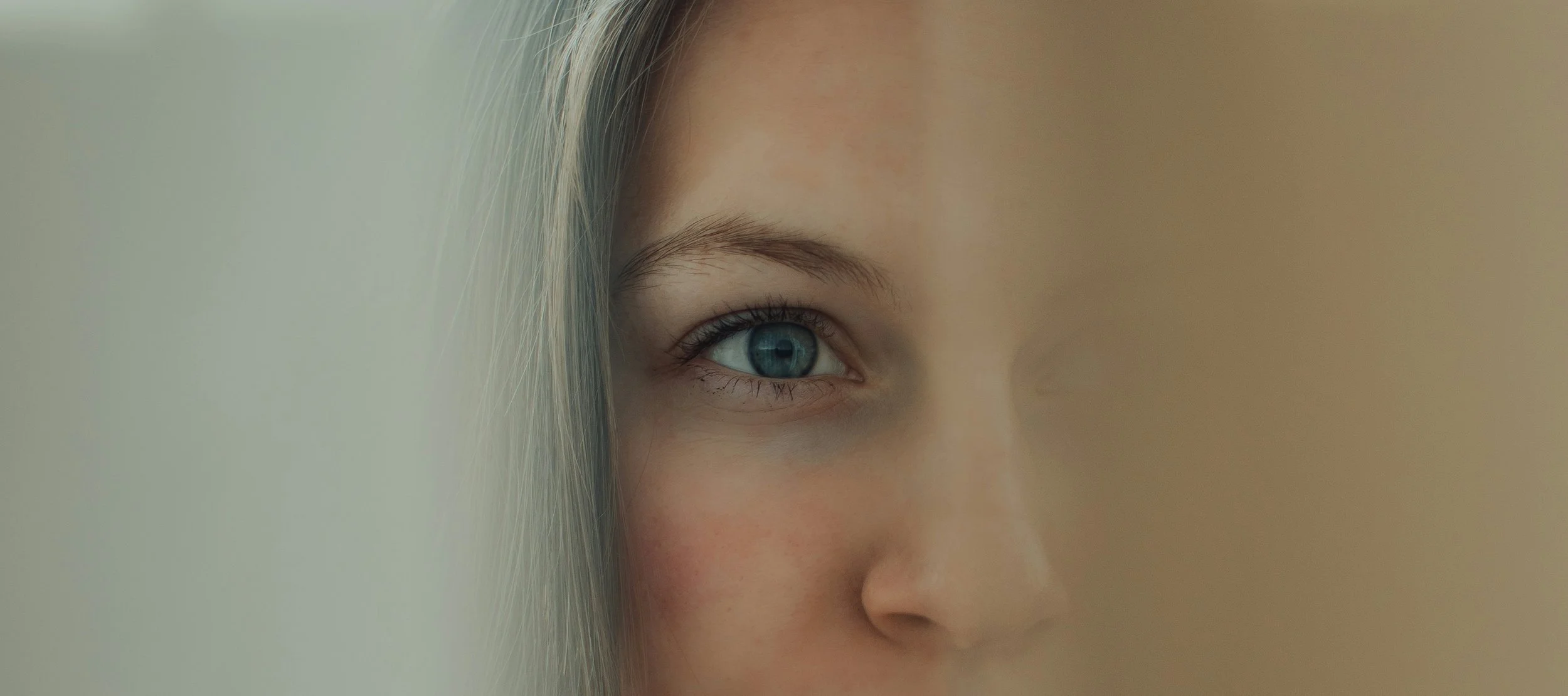 Close-up portrait showing subtle emotion, illustrating authenticity in online dating beyond curated profile images