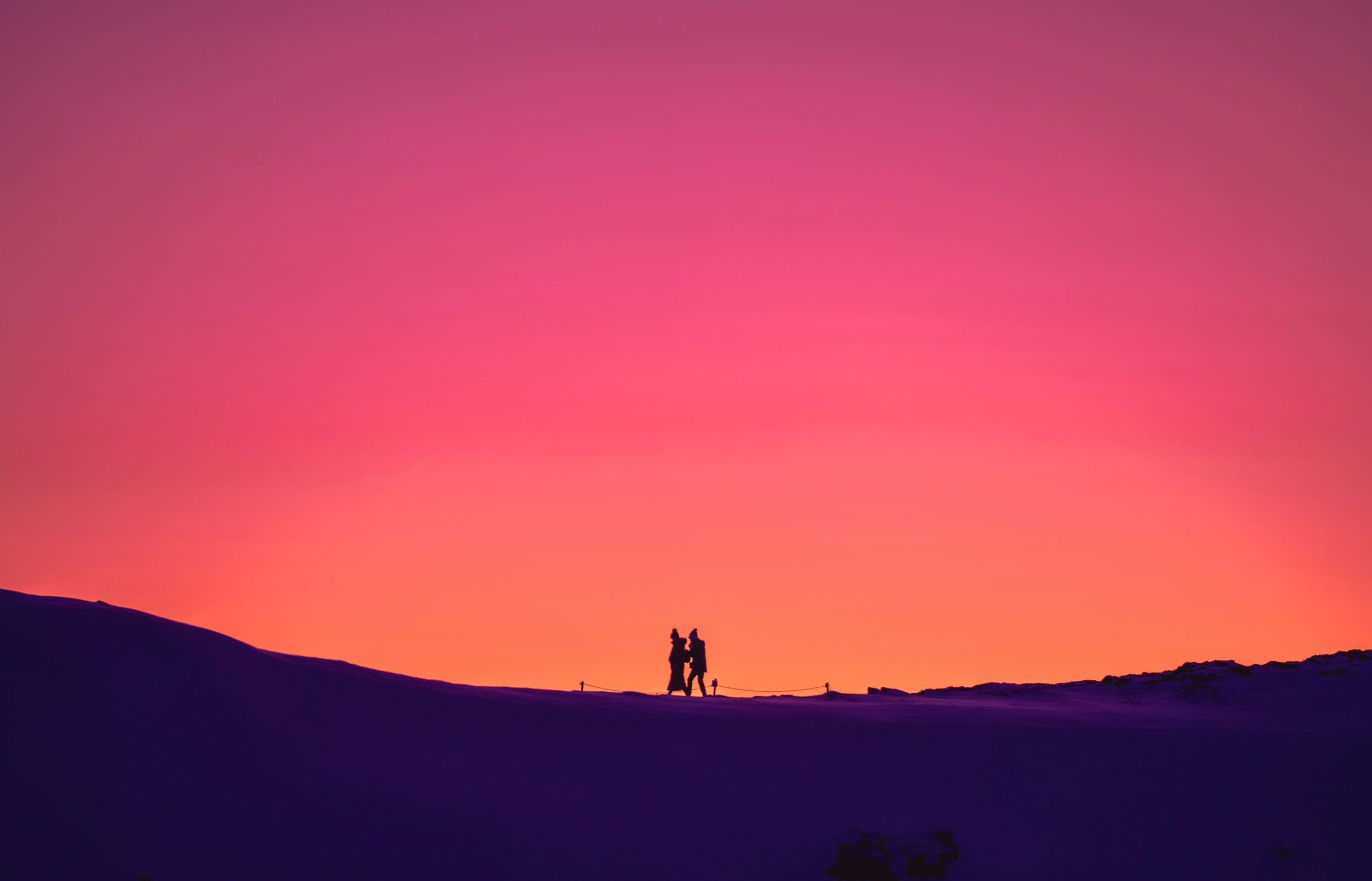 Two figures walking at sunset representing universal love and evolving Valentine’s Day traditions worldwide