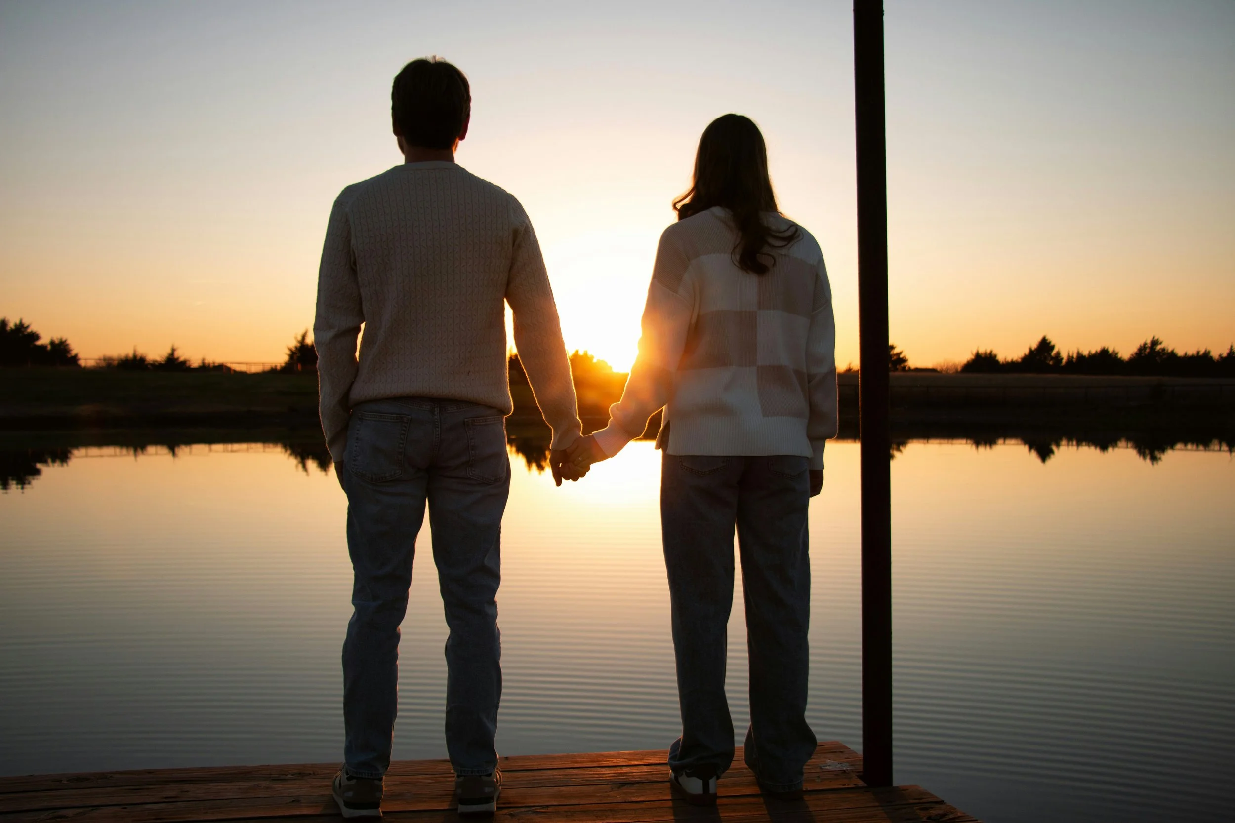Why we need relationships to feel closeness and emotional safety, shown through a couple sharing a quiet moment at sunset