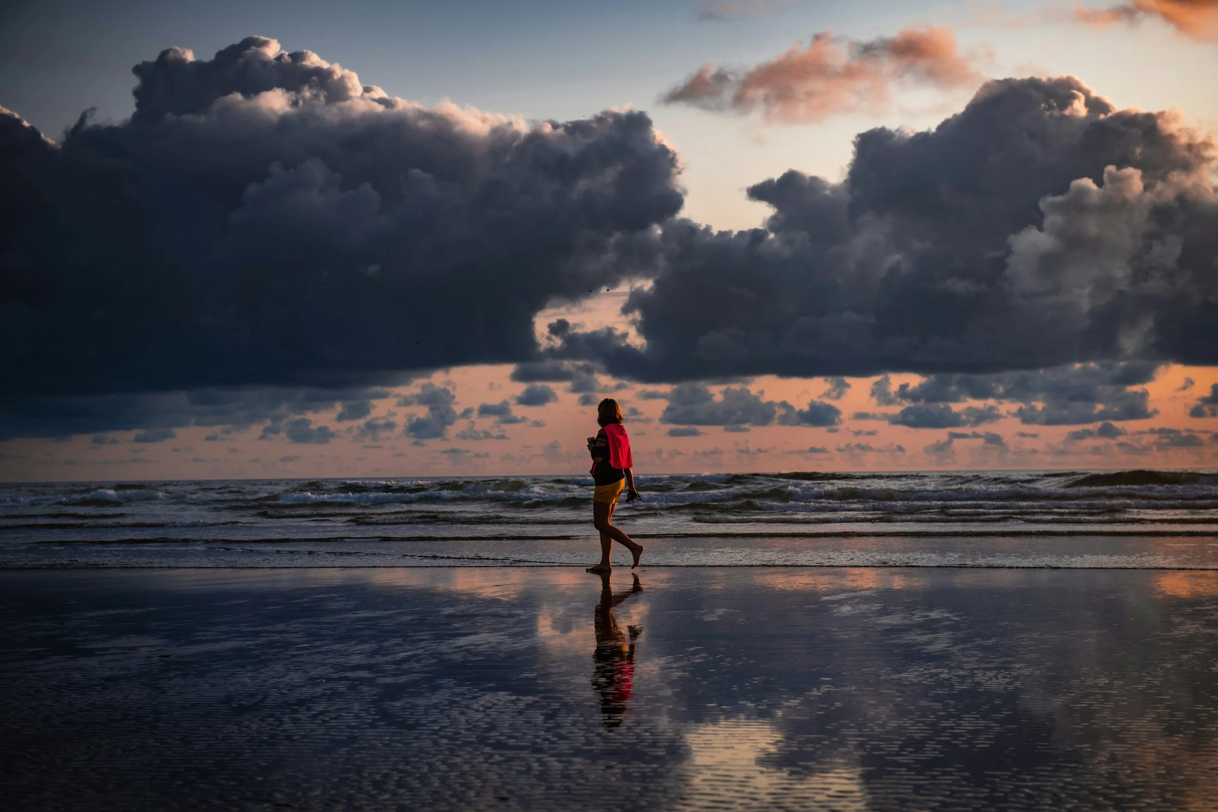 A person walking along the seaside, showing practical and calming Valentine’s Day ideas for singles