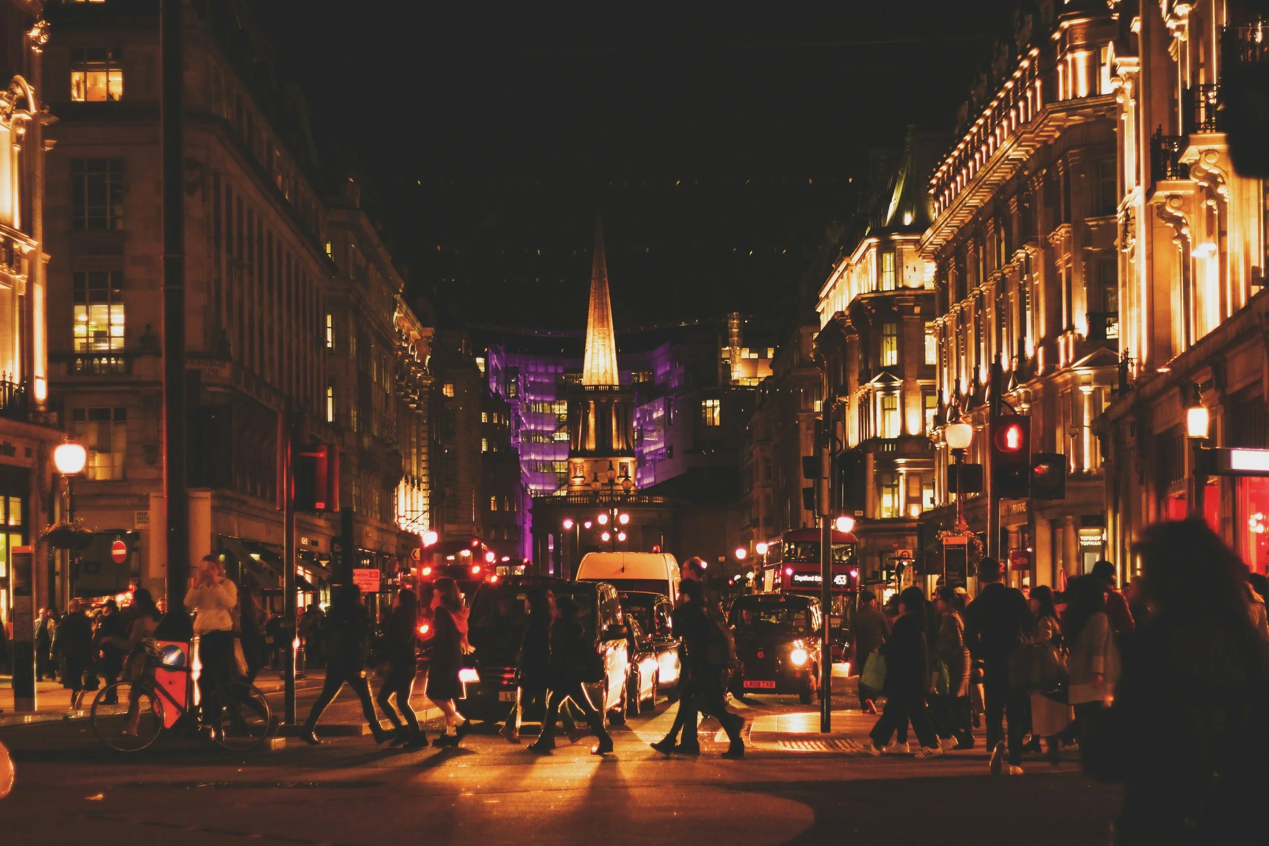 Crowded city street at night with people walking past each other, representing the fast pace of modern dating apps before dating app burnout