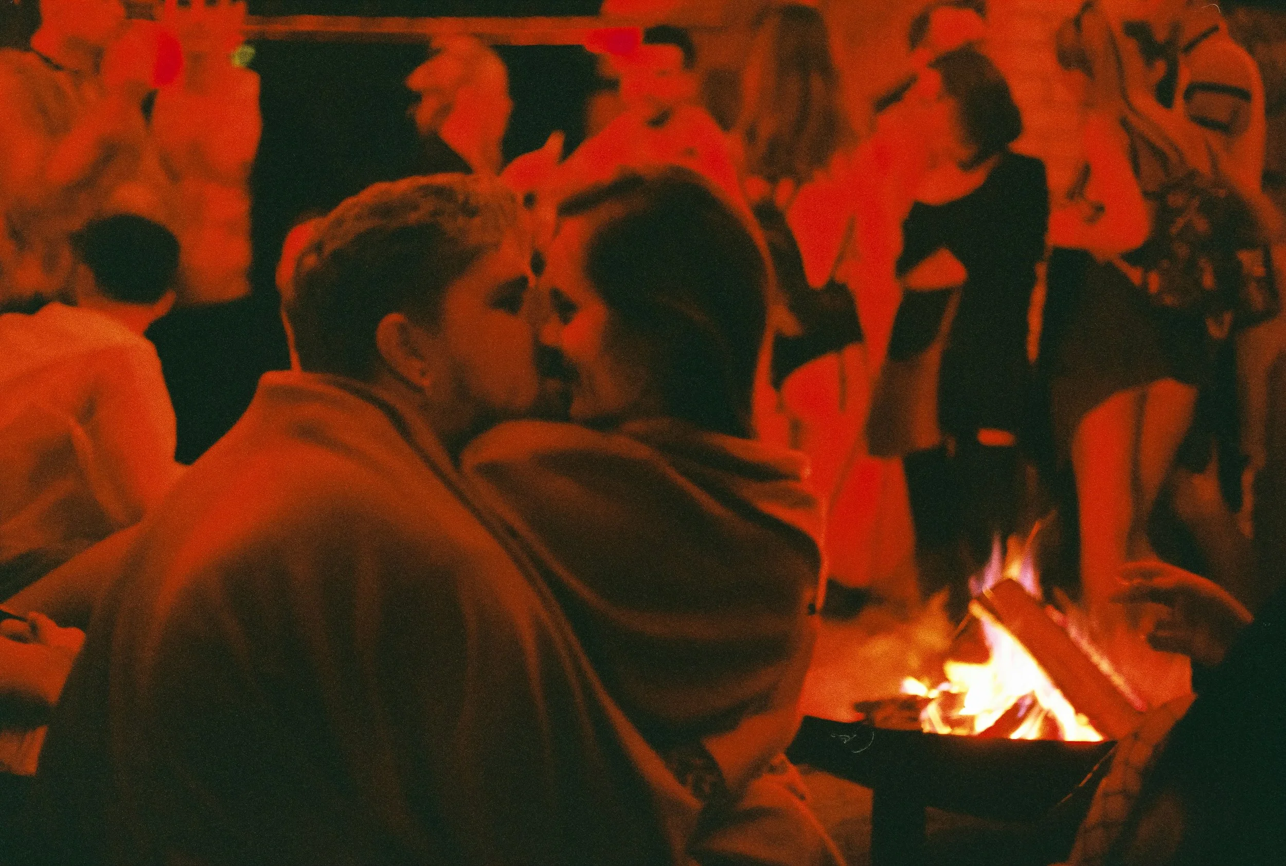 A couple relaxing by a fireplace during winter, representing cuffing season dating tips and the cosy, intimate atmosphere of winter relationships.