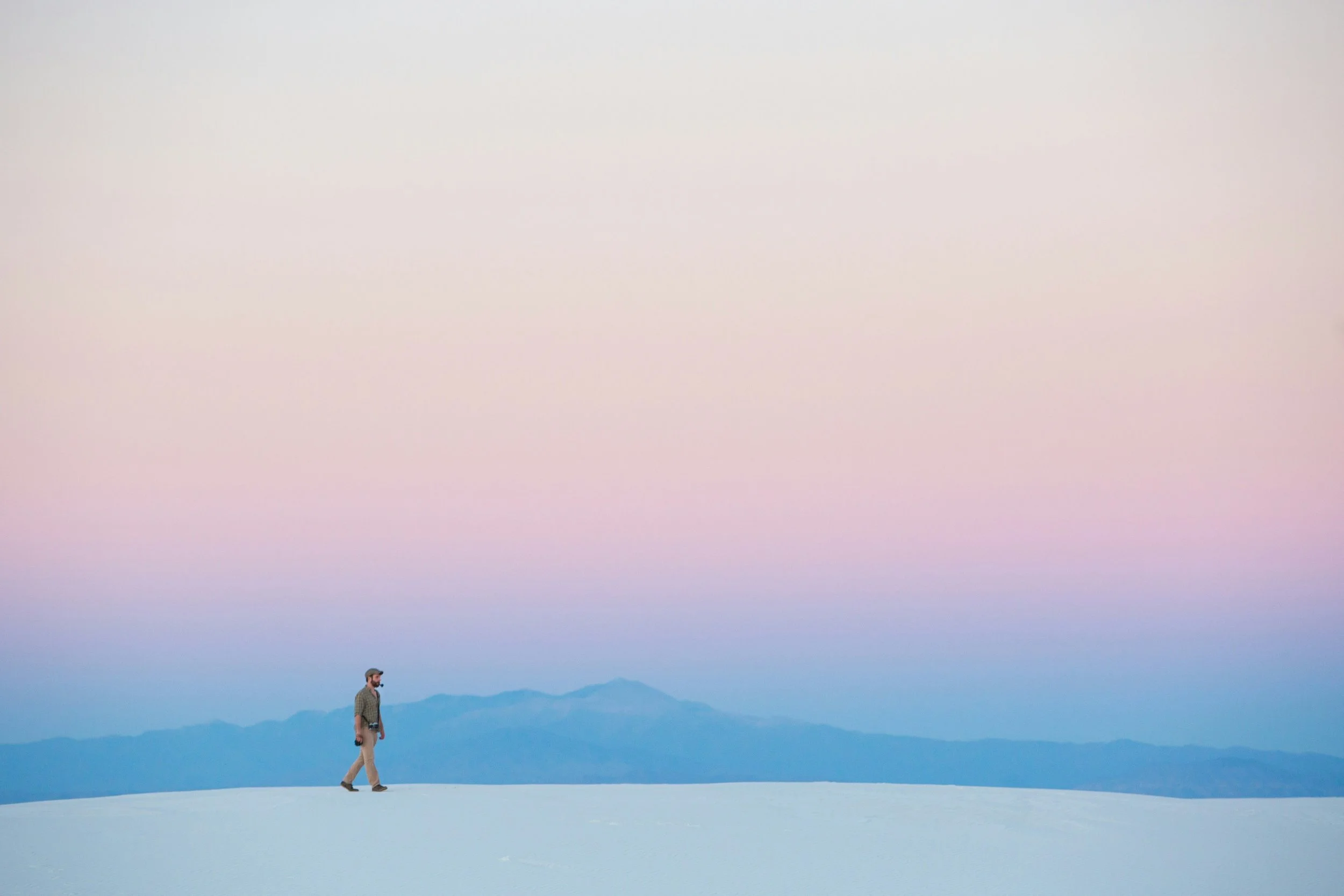 A person walking alone on a snowy mountain, symbolising the search for connection beyond dating app fatigue.