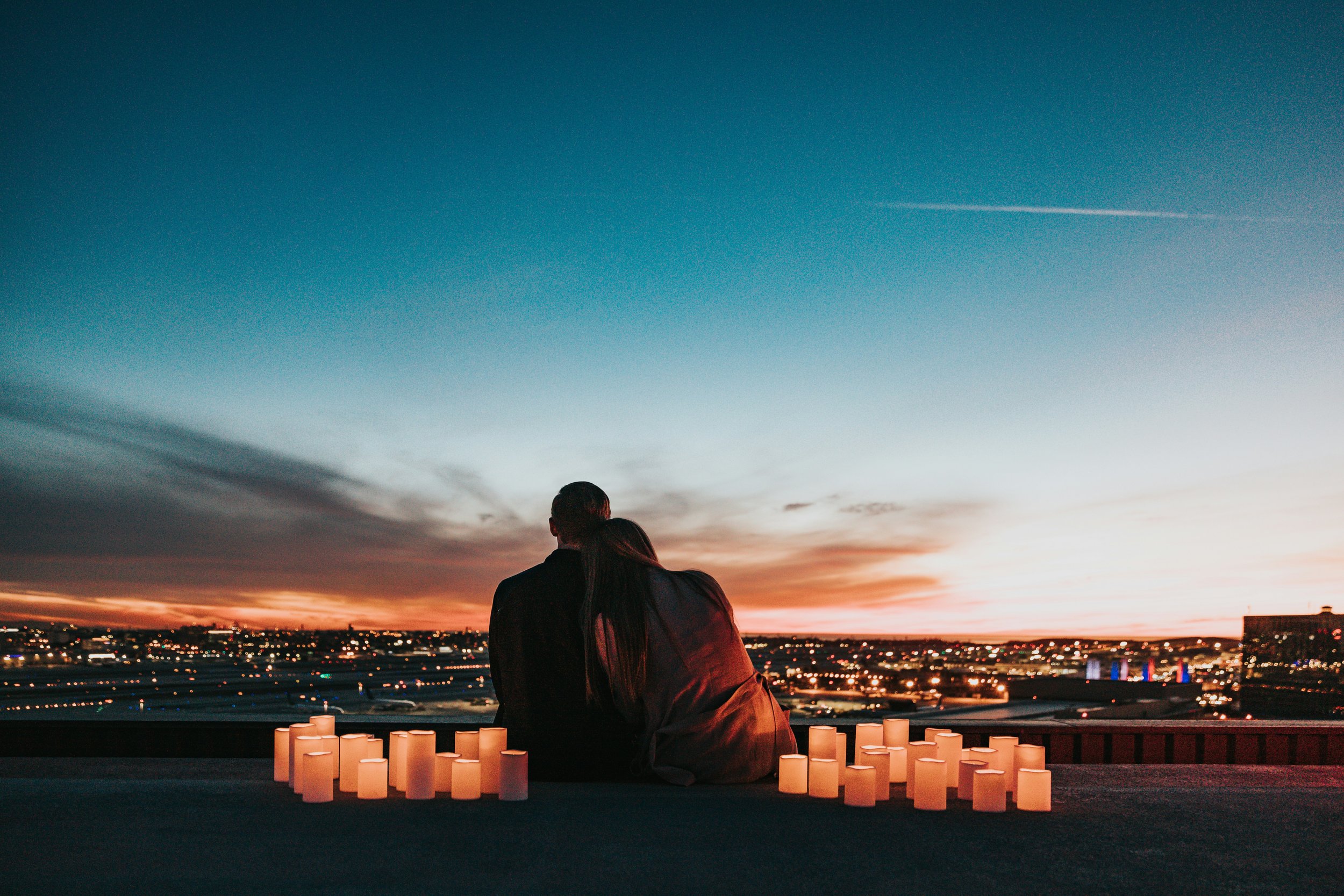 Couple sitting together overlooking a city, illustrating how consent in relationships evolves over time.