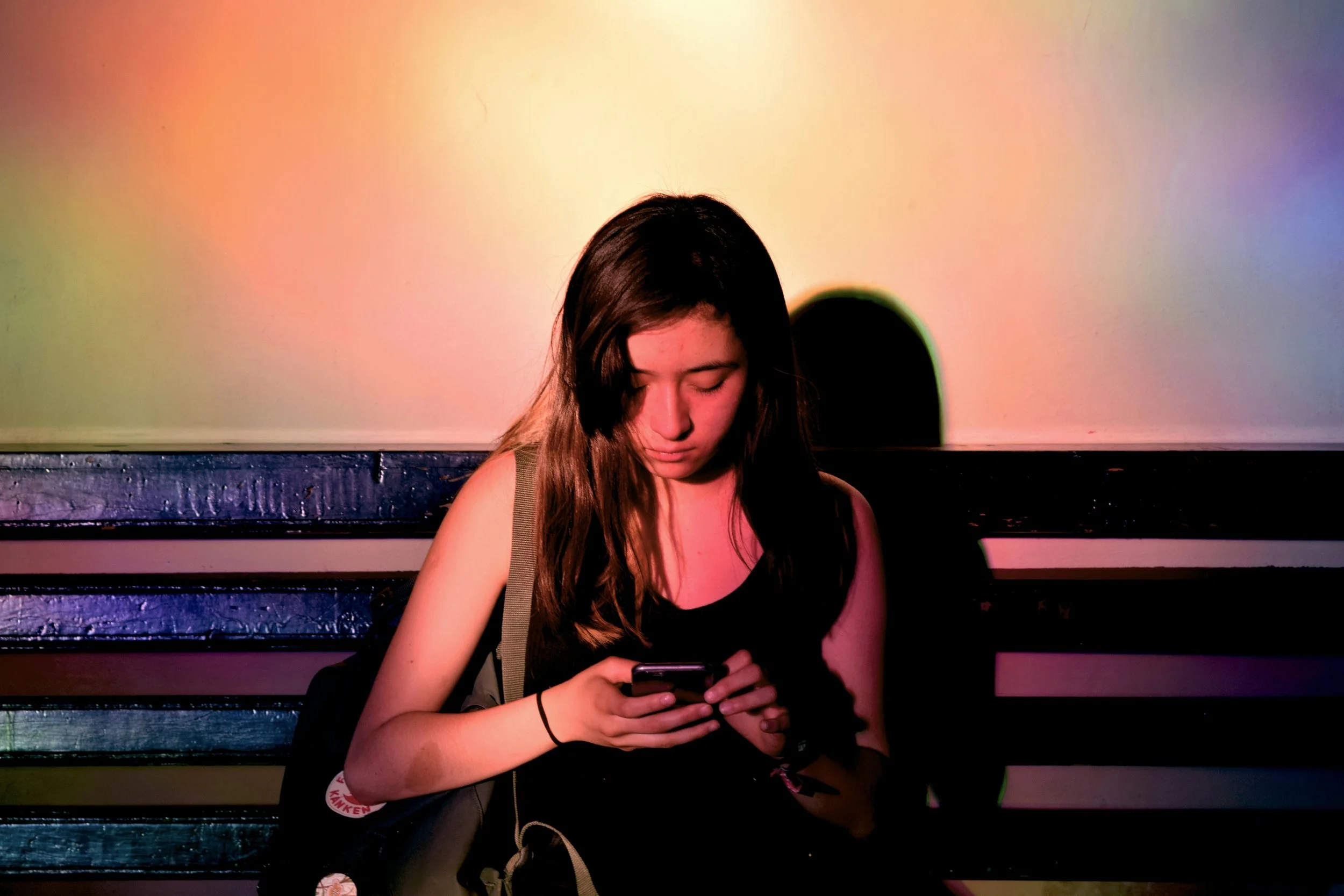woman checking phone looking uncertain — representing benching in modern dating and emotional ambiguity