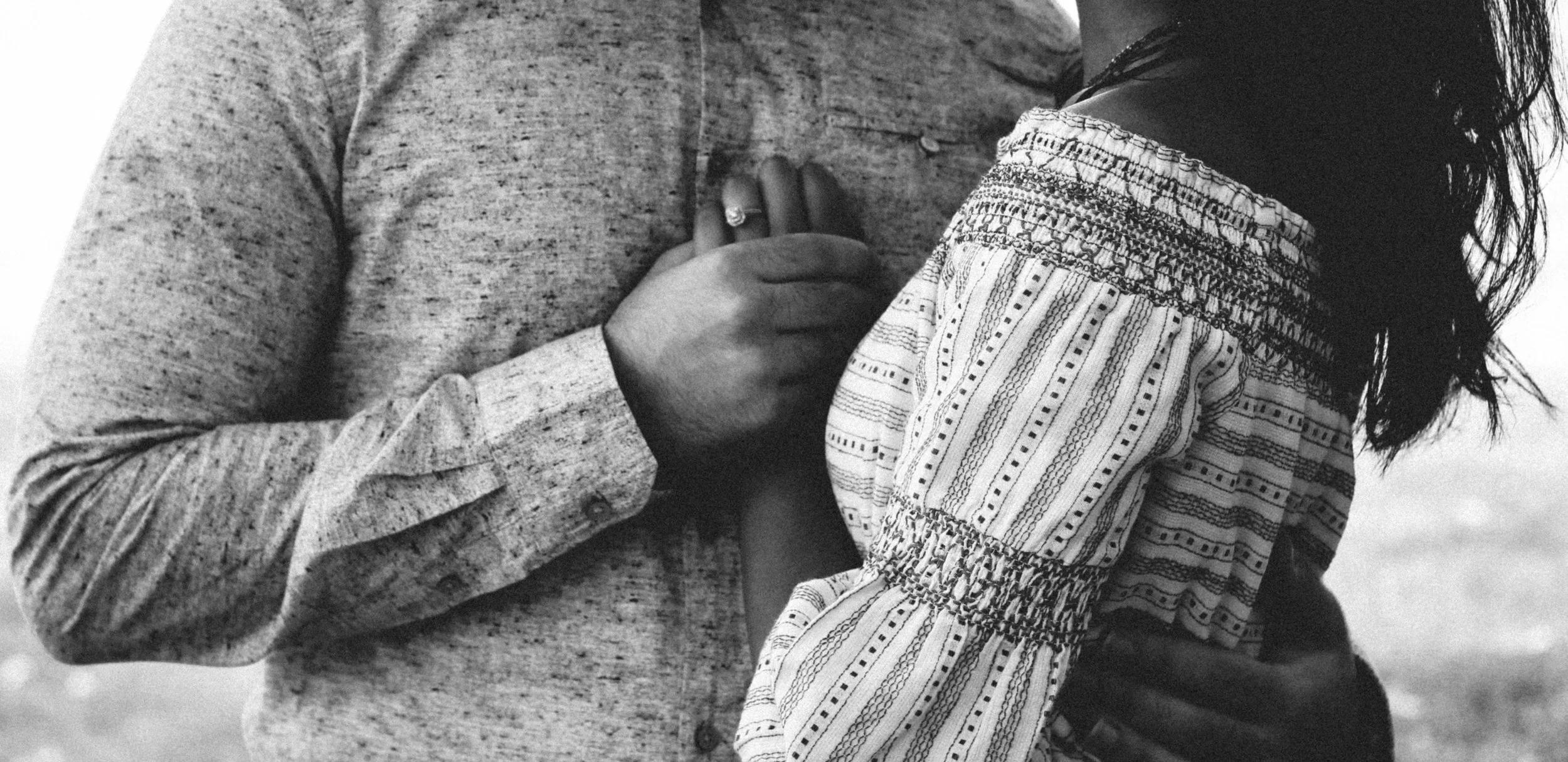 Black and white photograph of a couple embracing, representing authentic connection beyond dating app burnout