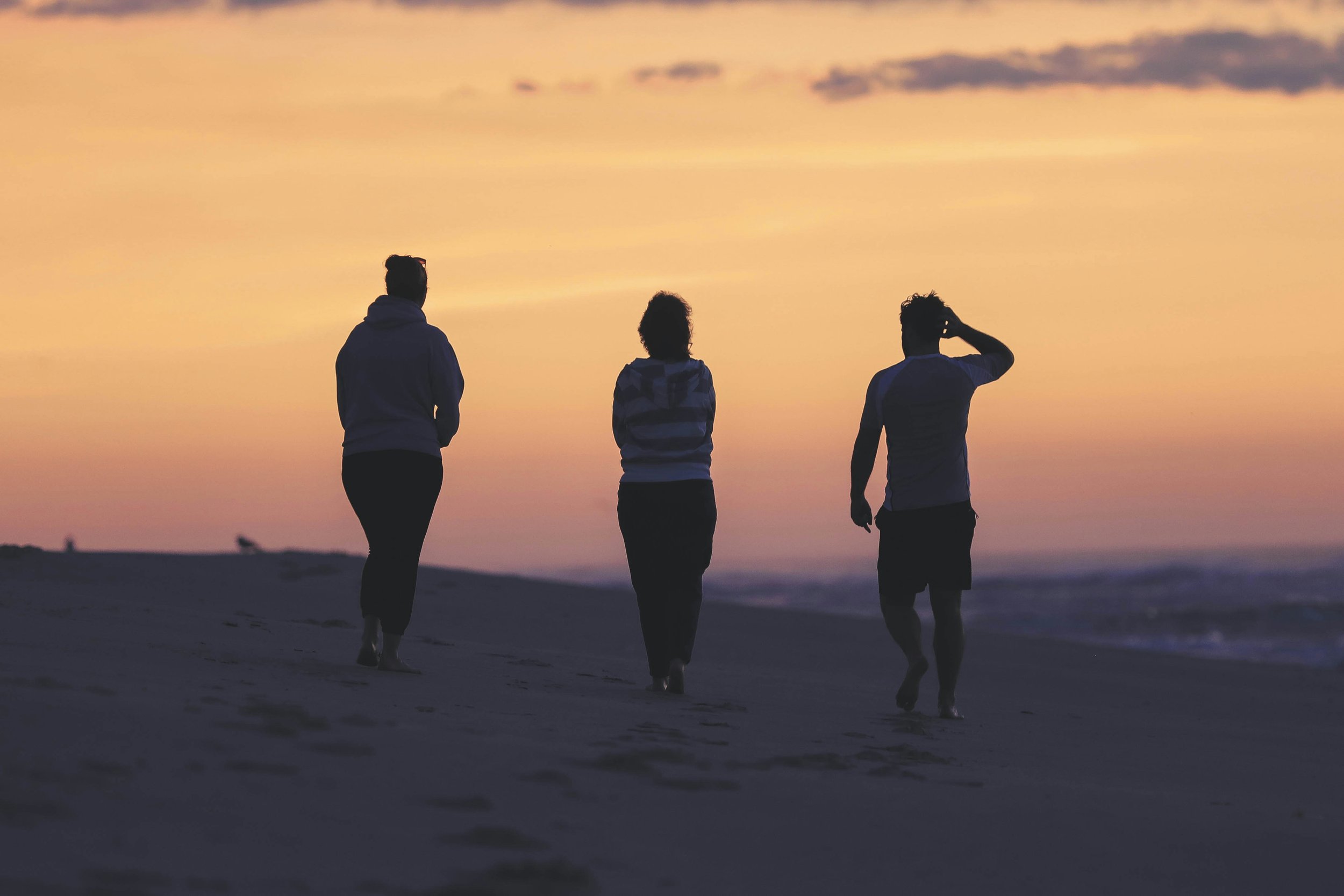Group walking together at sunset, symbolising dating for couples and open relationship dating
