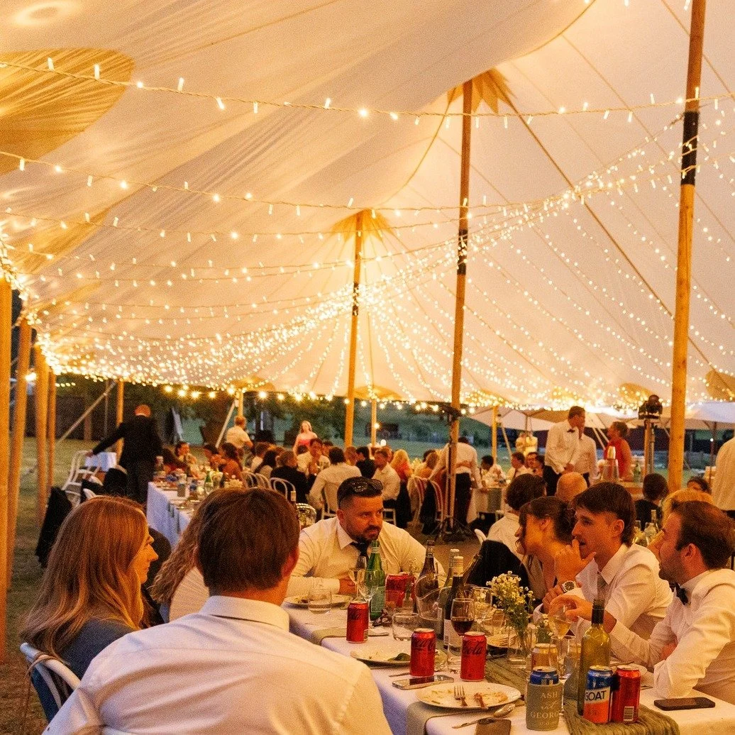 Ash &amp; Georgie&rsquo;s wedding under our Banjo Sailcloth Marquee.

A canopy of fairy lights ran through the marquee with the bridal table positioned to overlook a central dance floor.

We ensured the fairy lights were dimmable, so the mood can be 