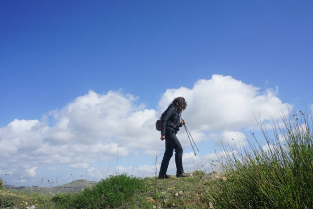 joanne karkour Scaling up coach  hiking outdoors  using trekking poles, under a blue sky - ThinkBIG | Scale Smart