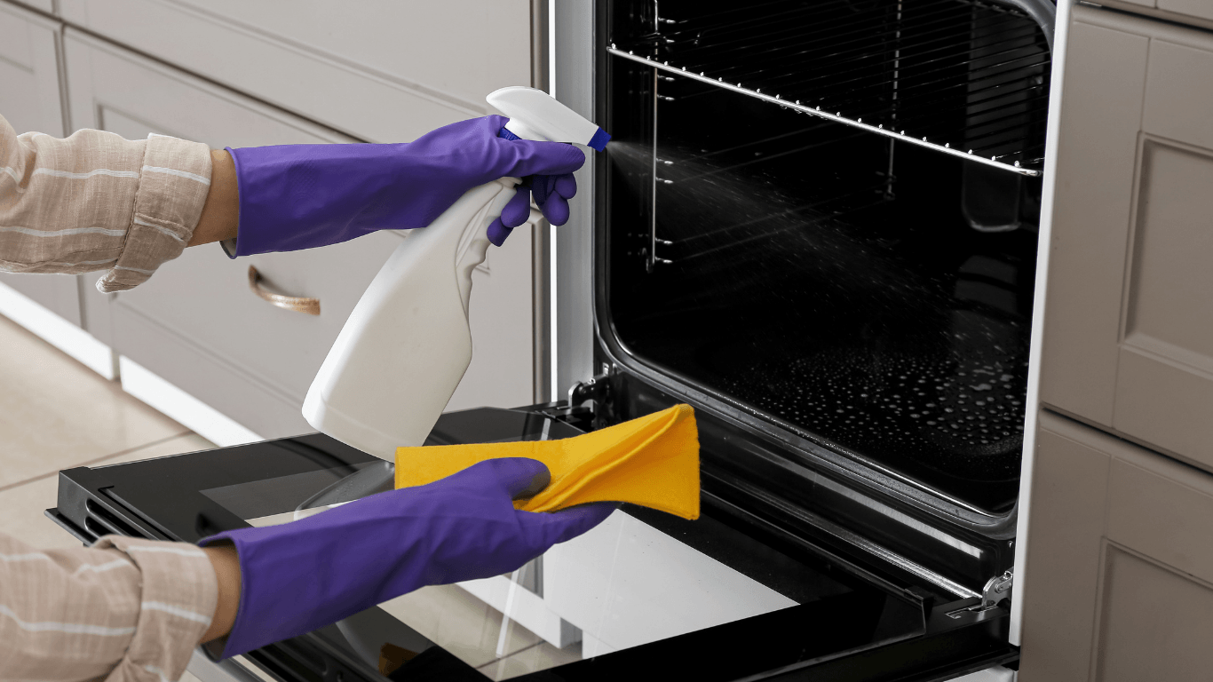 Professional cleaner deep cleaning an oven during a move-out cleaning in Yonkers NY
