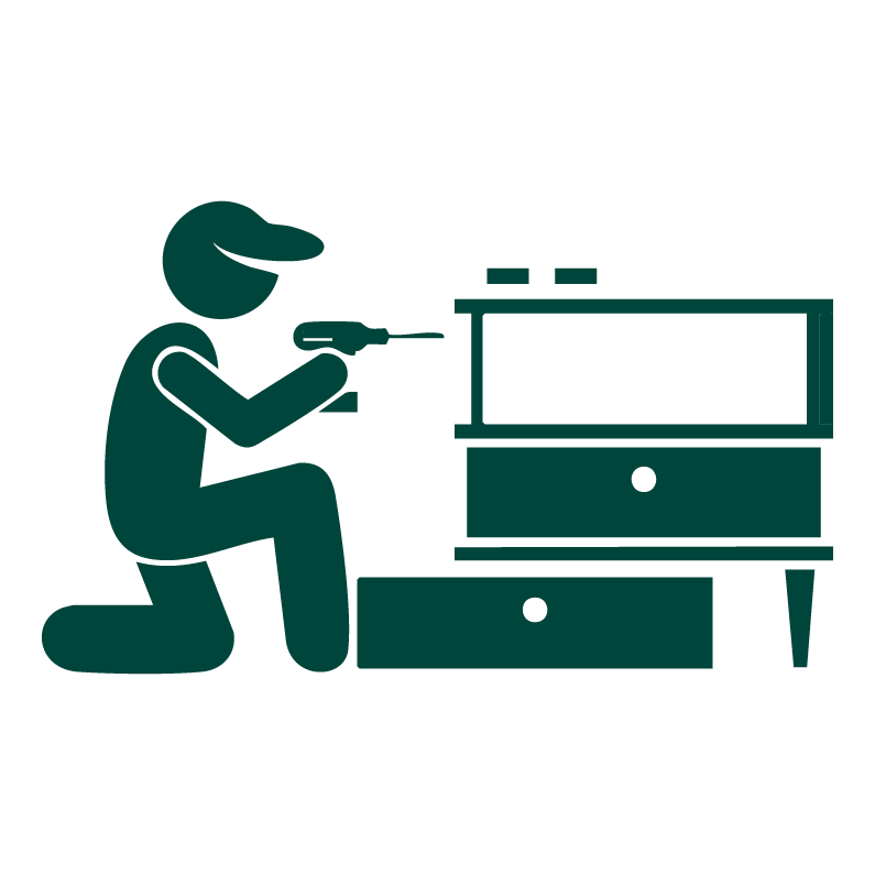 Silhouette of a person kneeling and using a screwdriver on a piece of furniture.