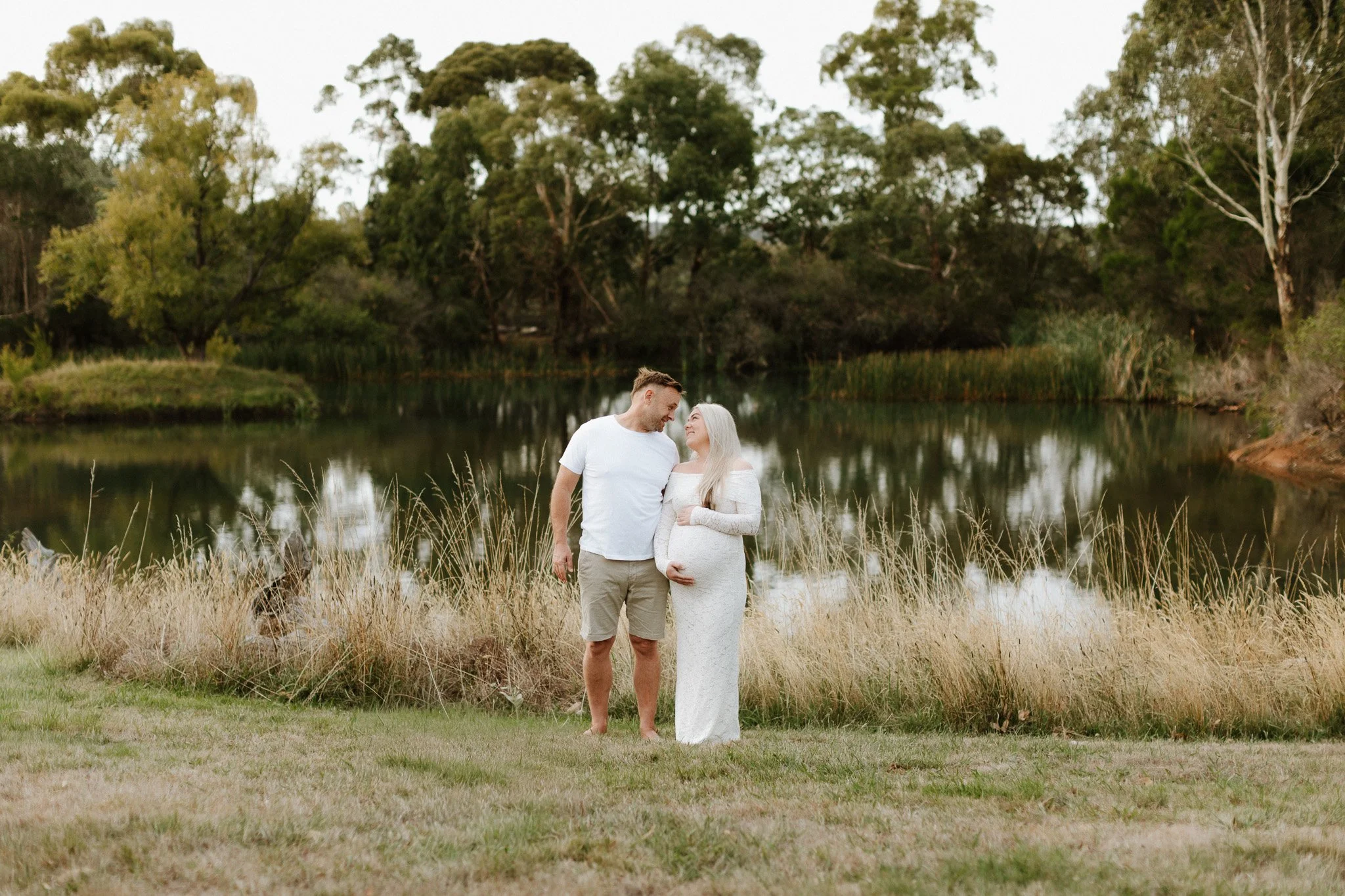 Couple Standing outdoors for maternity photoshoot in Bendigo Farm