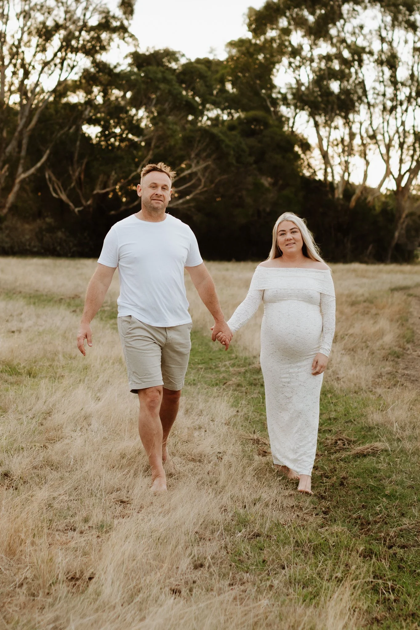 pregnant couple walking through family property, casual maternity photoshoot bendigo