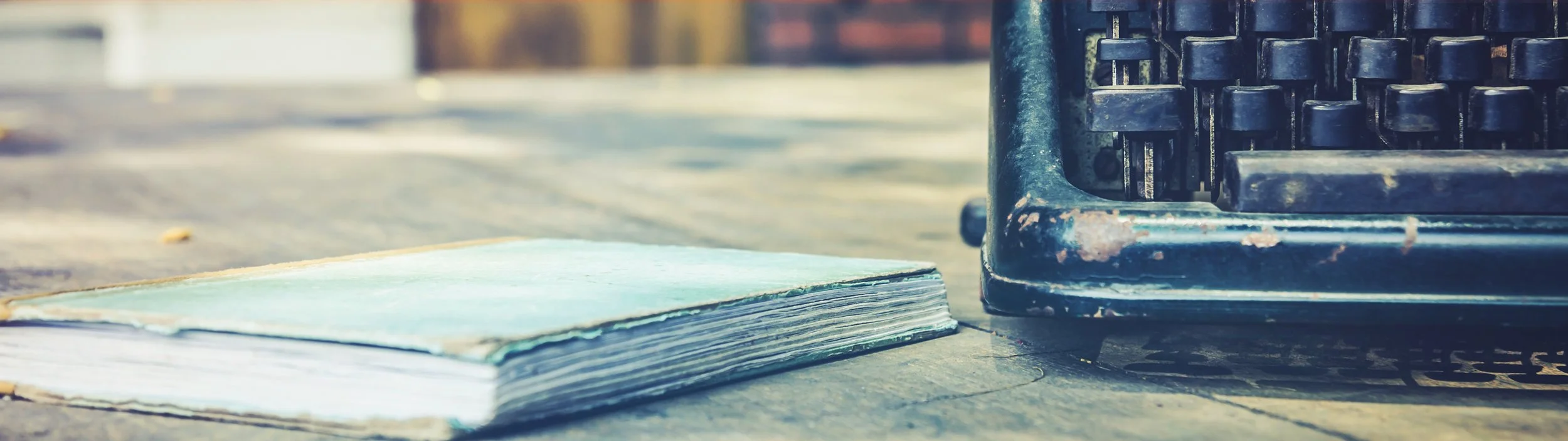Image of an old notebook and a writing machine