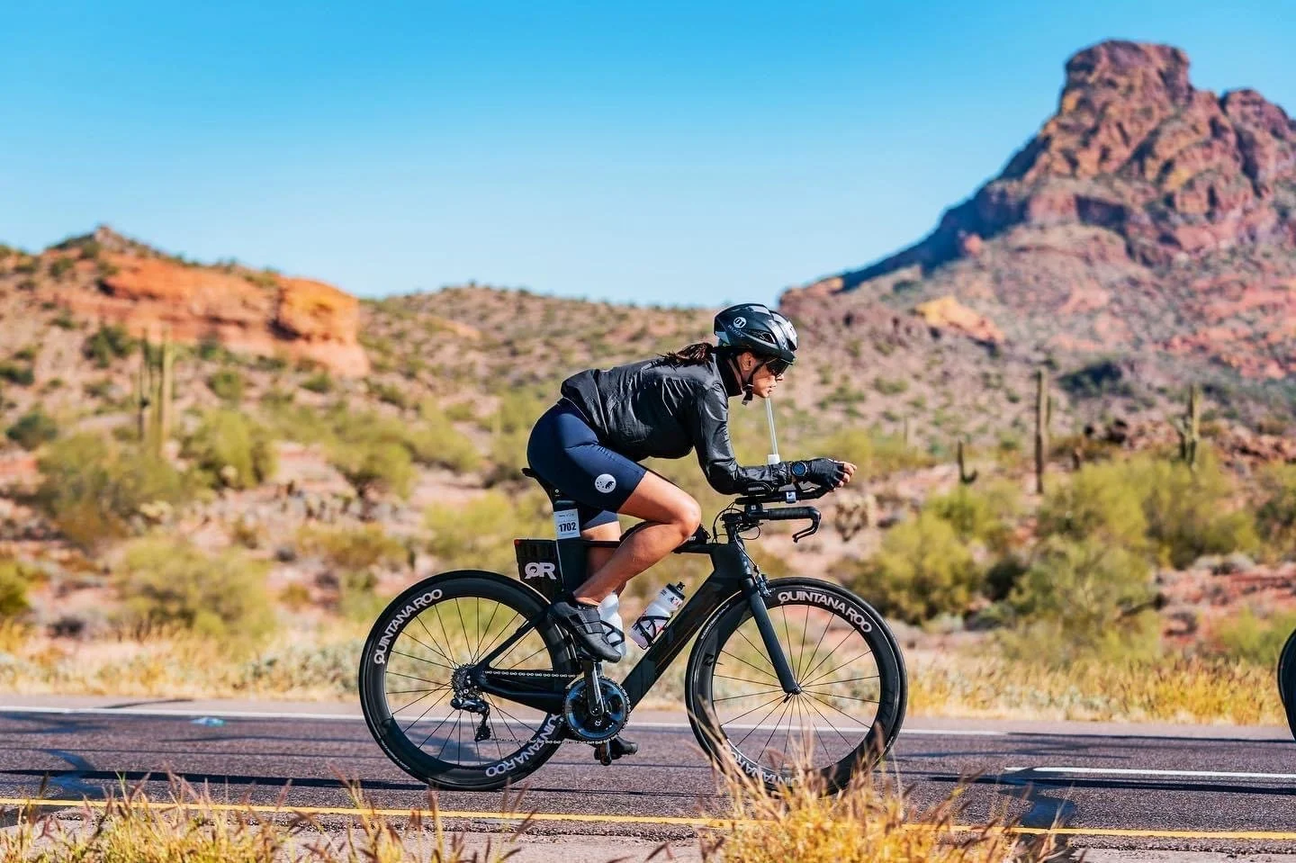 Woman riding bike in Ironman race