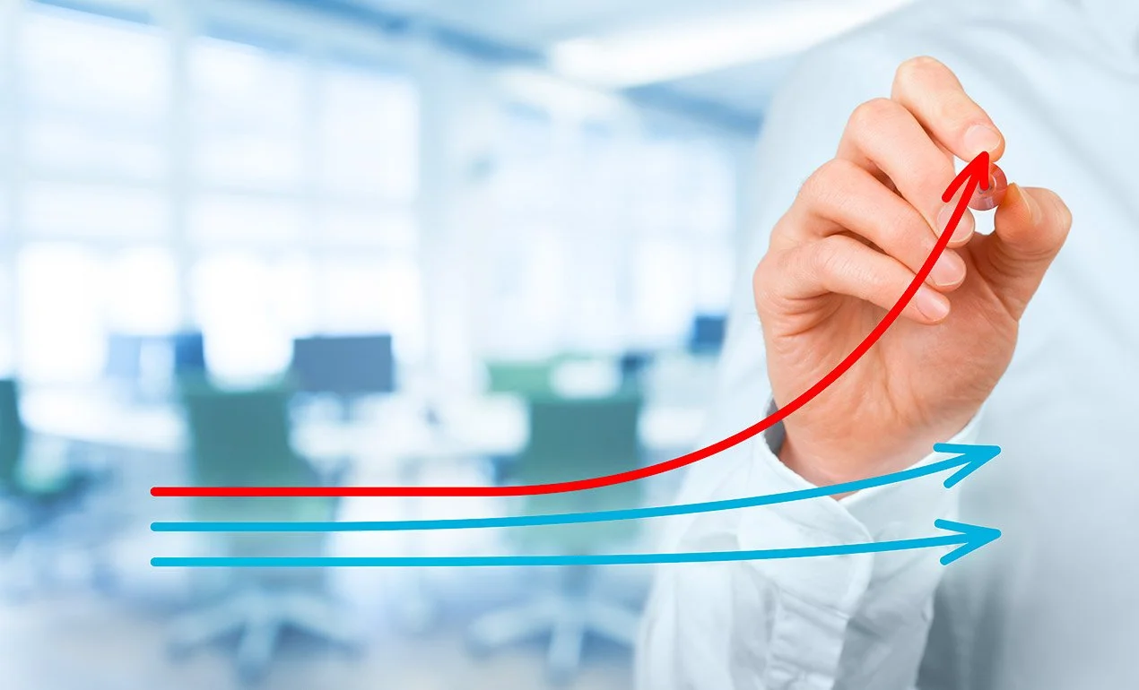 hand drawing upward-trending arrows on glass wall to indicate positive results