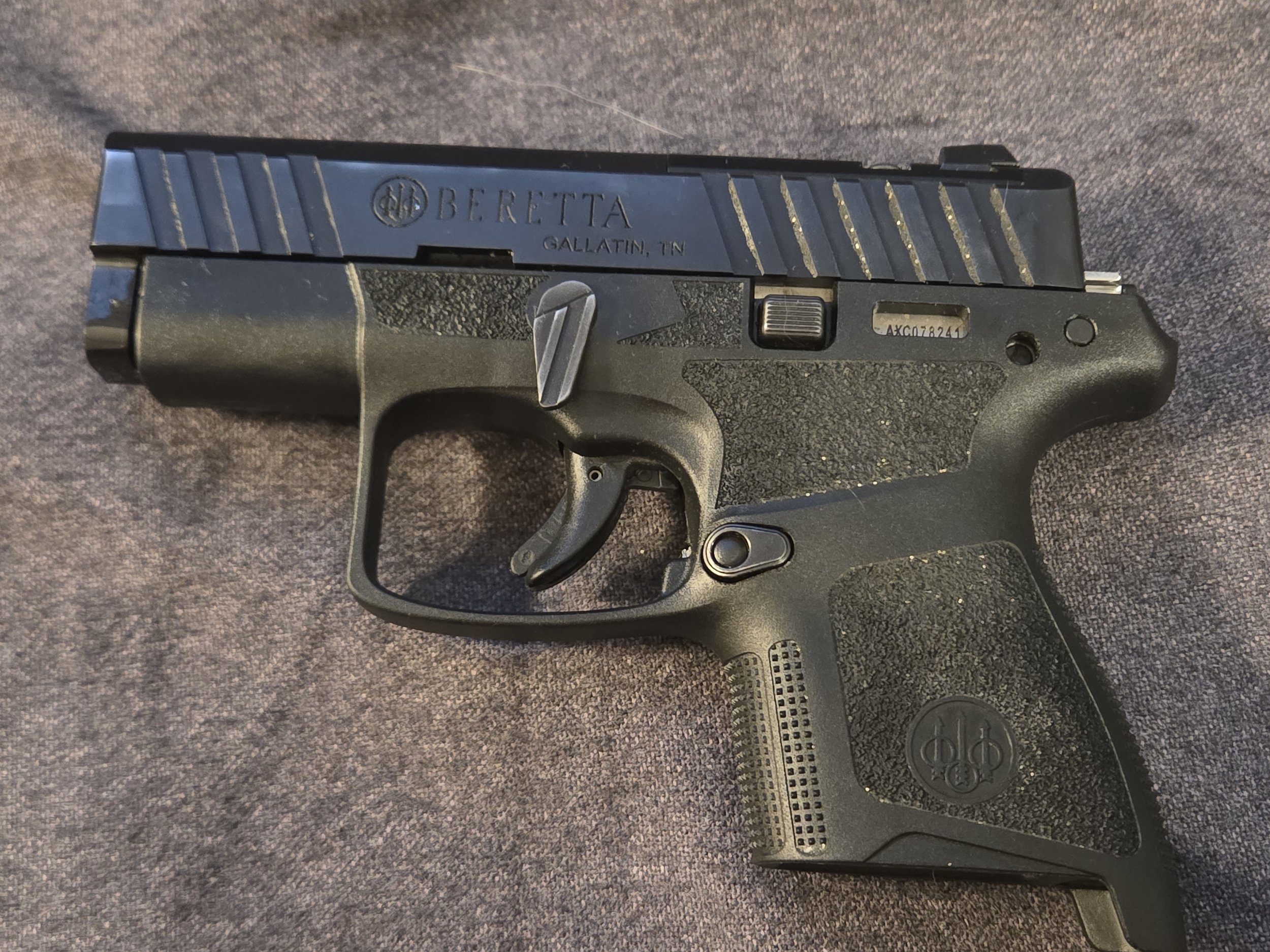 Beretta APX A1 Carry micro-compact 9mm pistol in black with aggressive grip texturing, shown with the flush-fitting 6-round magazine removed