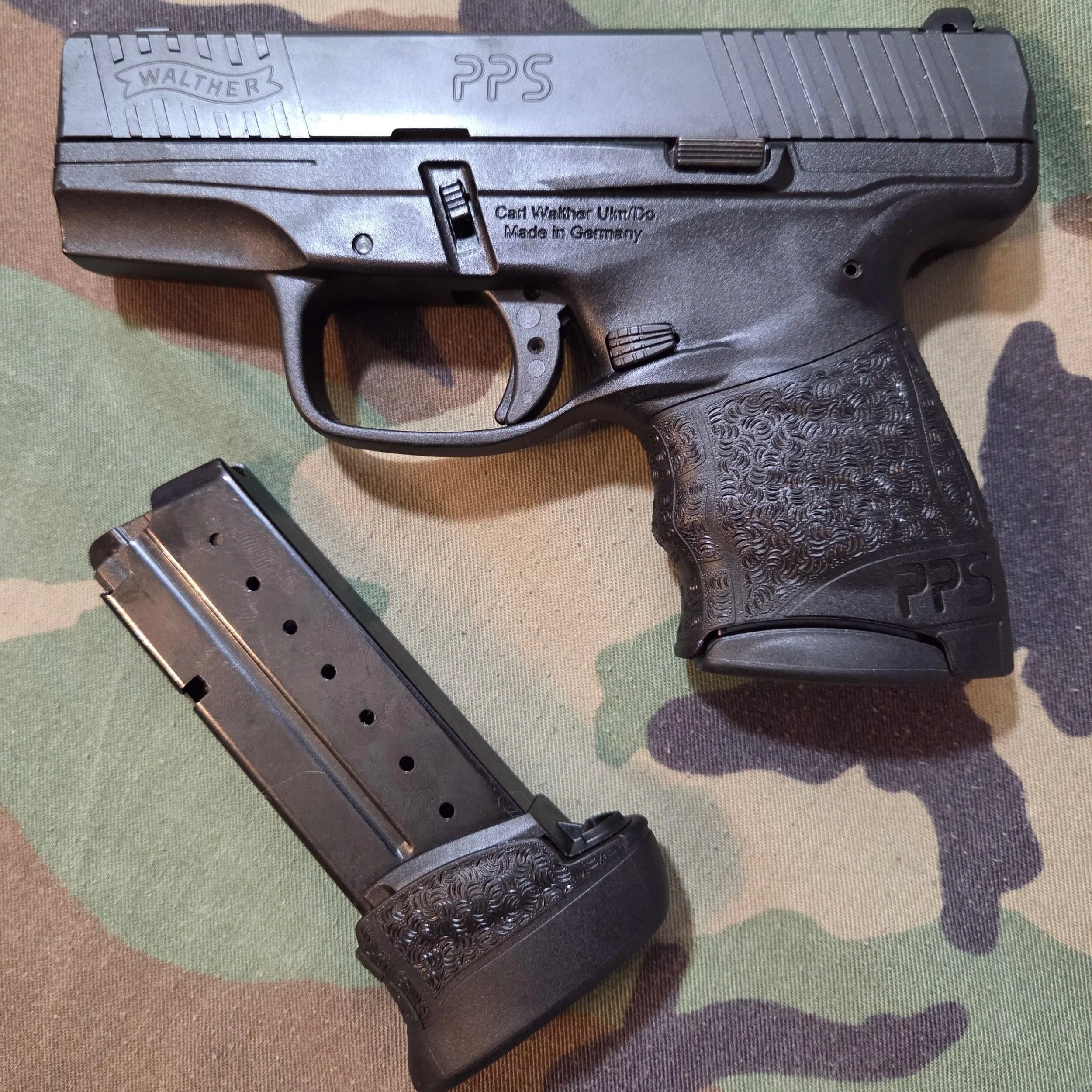WALTHER PPS M2 WITH WOODLAND CAMOUFLAGE BACKGROUND