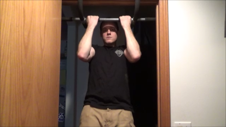 individual practicing pullups in a doorway