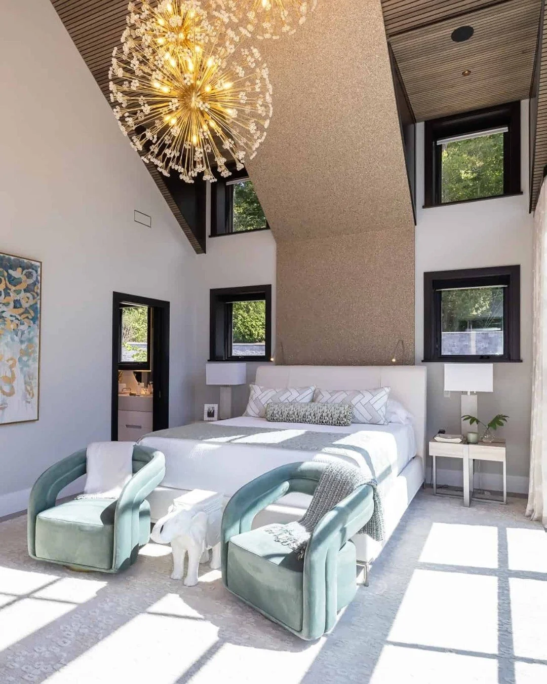 Could you picture yourself waking up here? ☀️

This light-filled primary suite pairs floor-to-ceiling windows, a show-stopping chandelier, and modern black-and-white design for a space that feels both peaceful and powerful.
Custom living, done right.