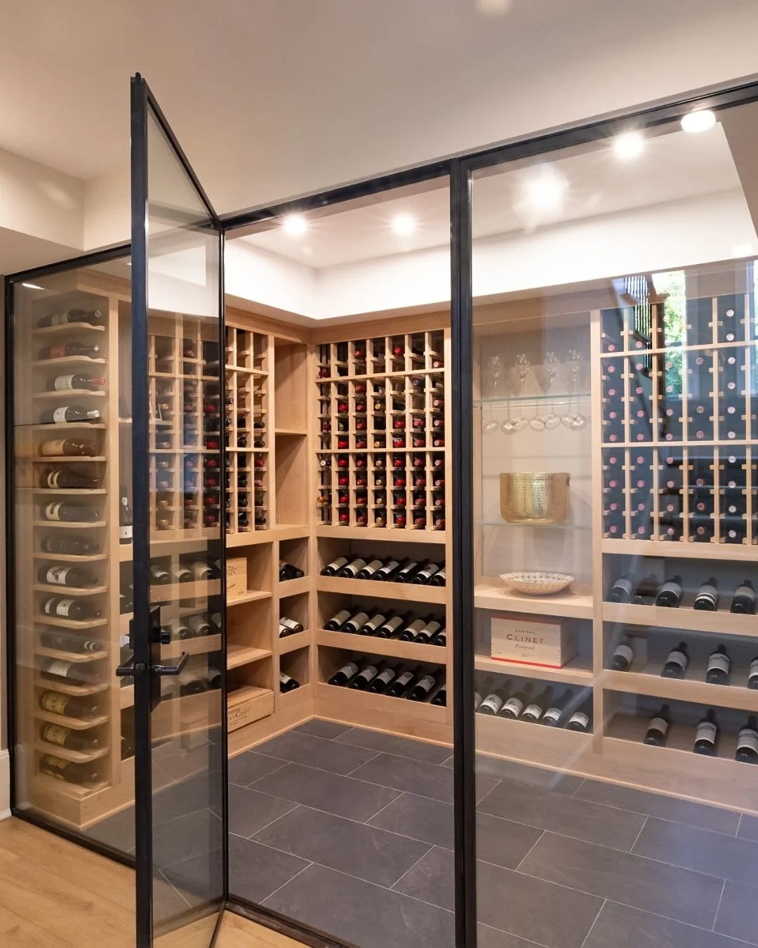 A custom wine room designed to elevate both the home and the experience. 🍷

This project features floor-to-ceiling custom millwork, precision wine racking, integrated display shelving, and a sleek glass enclosure that keeps the collection visible wh