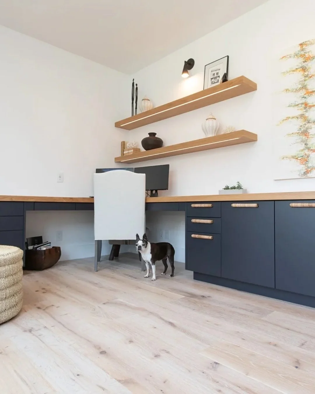 A workspace that actually works. Clean lines, warm wood tones, and custom built-ins keep everything organized without sacrificing style. Floating shelves add just enough personality, while the deep cabinetry grounds the space. And of course, every go