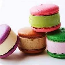 Colorful macarons in pink, green, brown, purple, and white