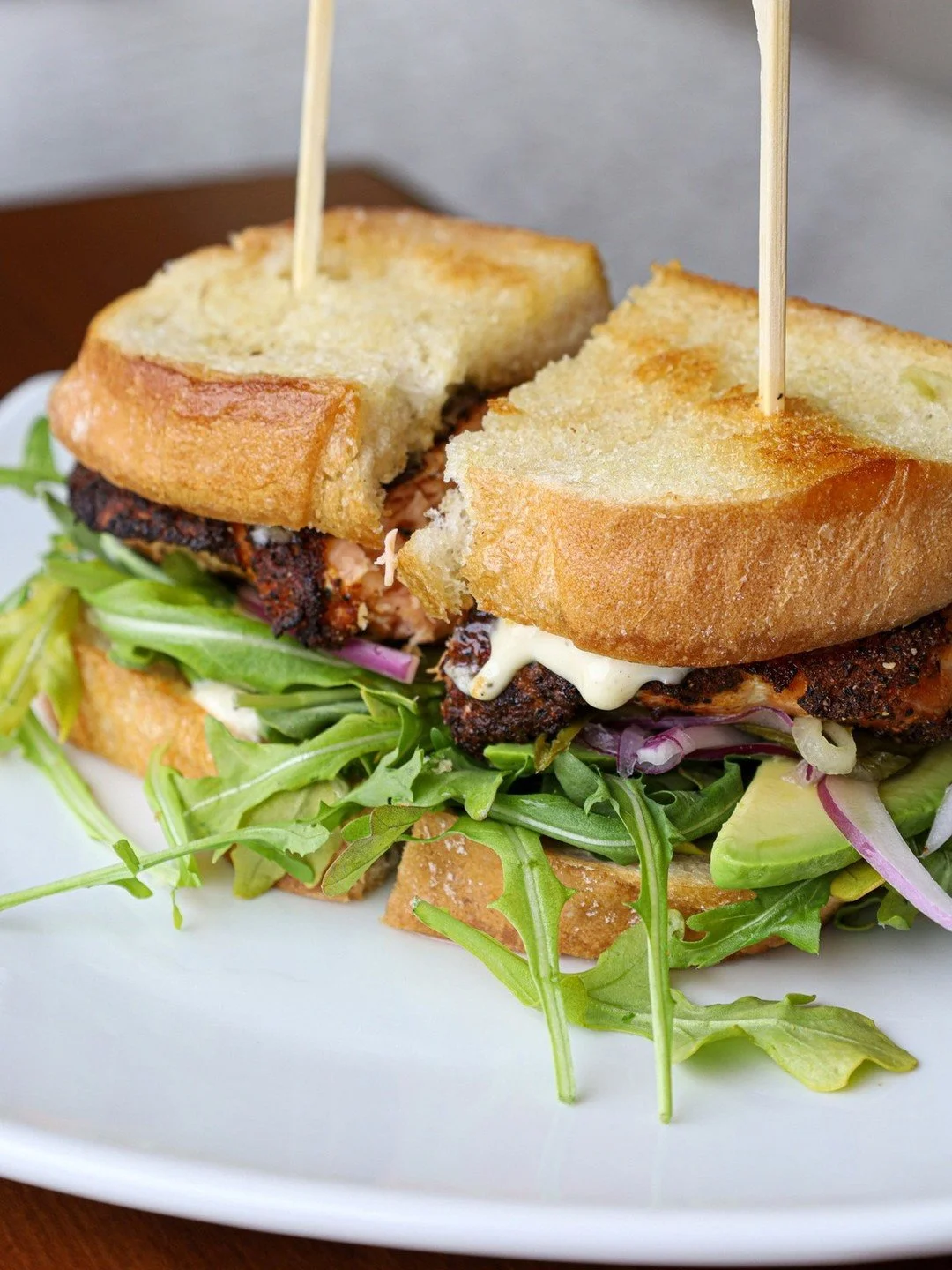 Stacked, fresh, and full of flavor 🐟🥑 The Blackened Salmon Club hits all the right notes &mdash; ciabatta, baby arugula, avocado, pickled reds, and zesty lemon-caper sauce.

Open today 9am-9pm!
View full menu: Link in Bio

#MidtownSocial #DetroitEa