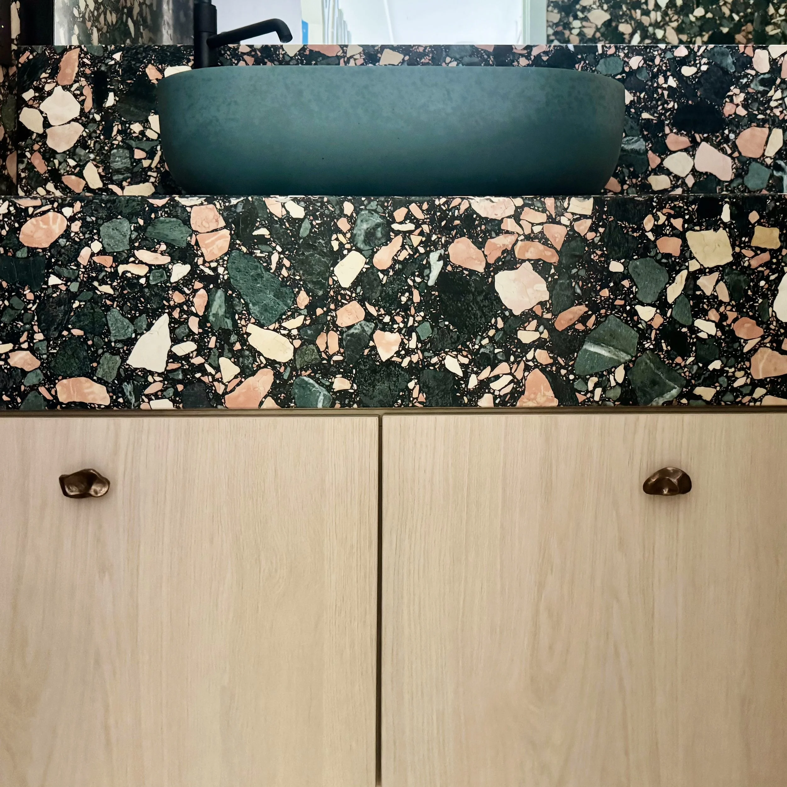 Detail shot of a bathroom vanity; showing some of my favorite mix of materials and selections from the Hillside Guest House. That @artistic_tile terrazzo is a showstopper, seamlessly running from backsplash-to-counter-to-face... But also that @kastco
