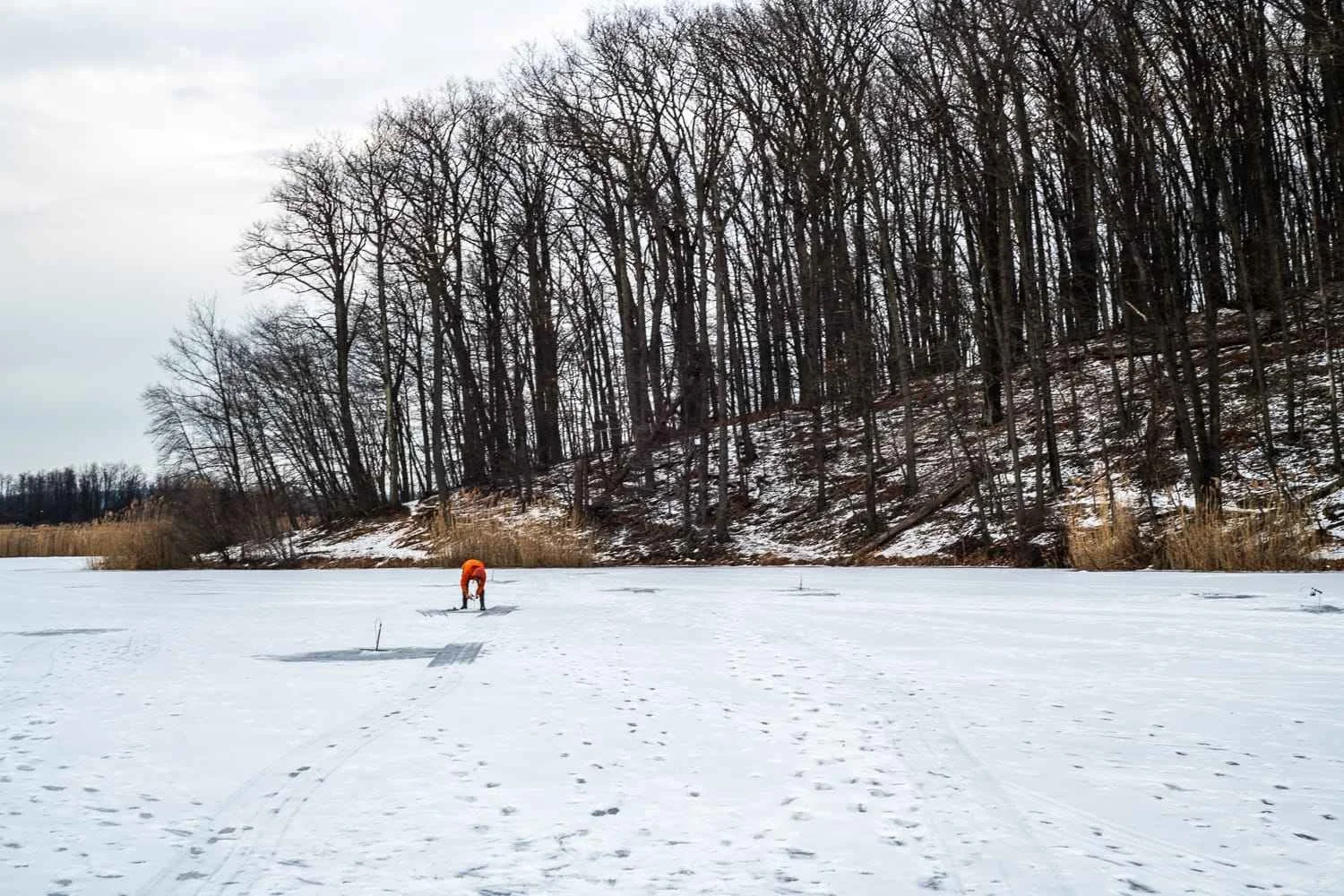 Oliver Round checking a Jaw Jacker on Round Valley Pond.