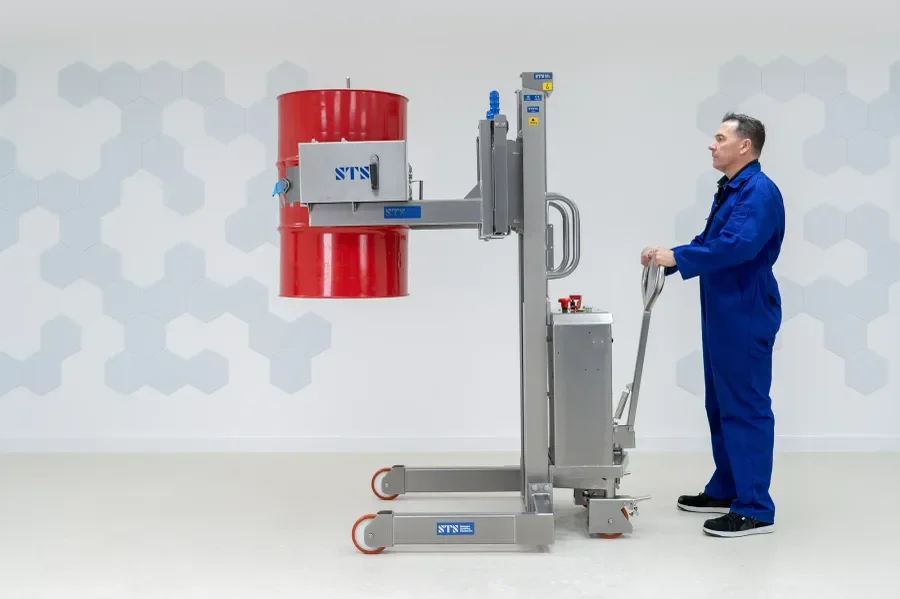 Image of stainless steel drum rotator being operated by a man 
