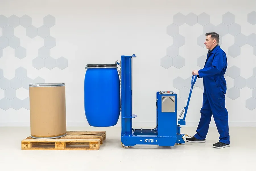 person operating the electric drum lifter to move a blue plastic barrel