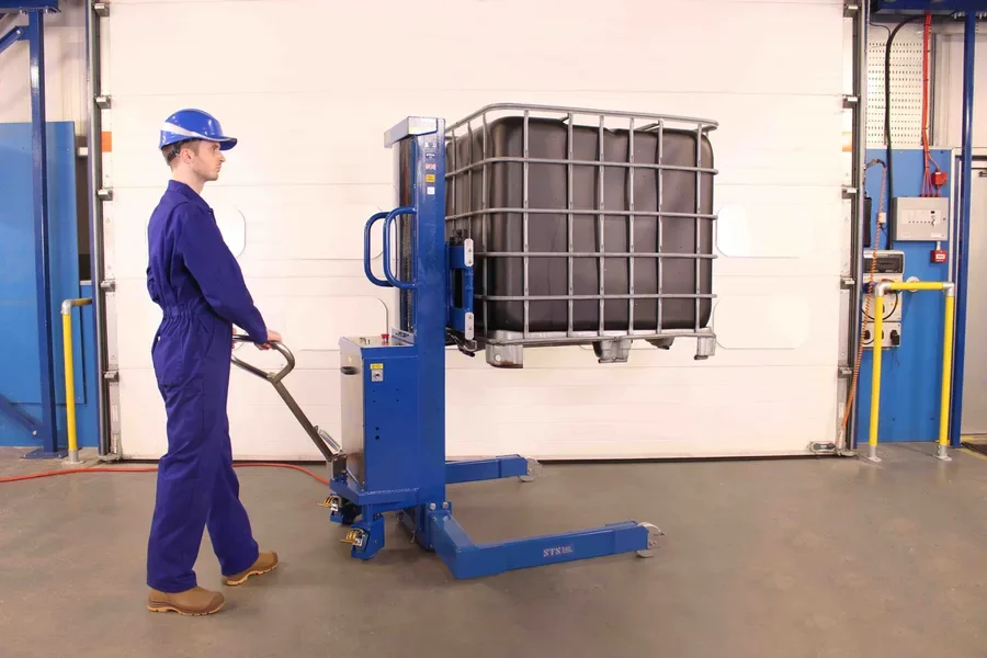 Shows operator steering the stacker truck with the tiller steering