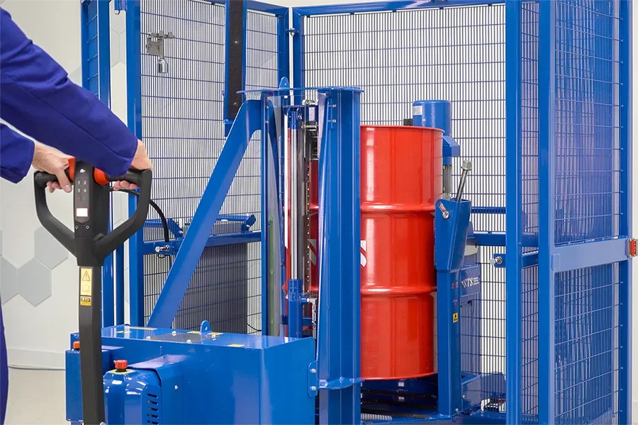 Drum lifter loads a drum into a mixing machine