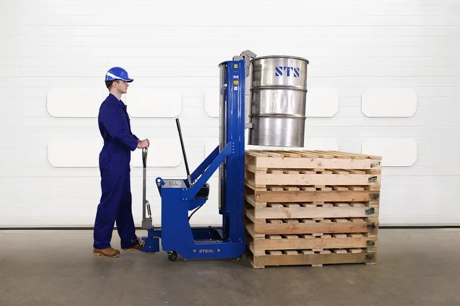 Operator demonstrating lifting a steel drum very high onto a stack of pallets