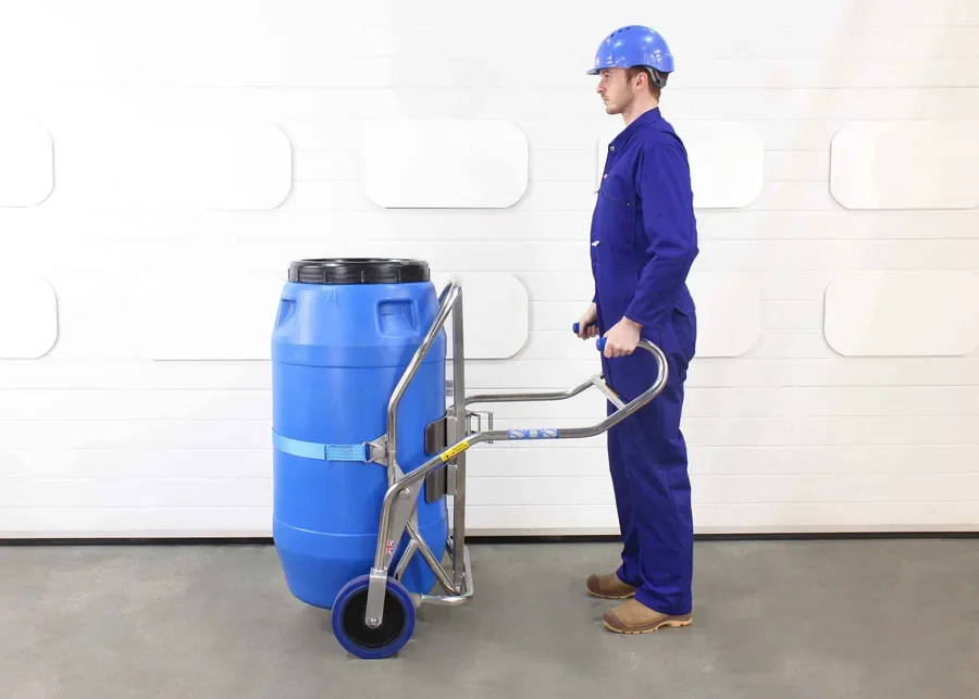 operator using the drum truck to lift screw top drums